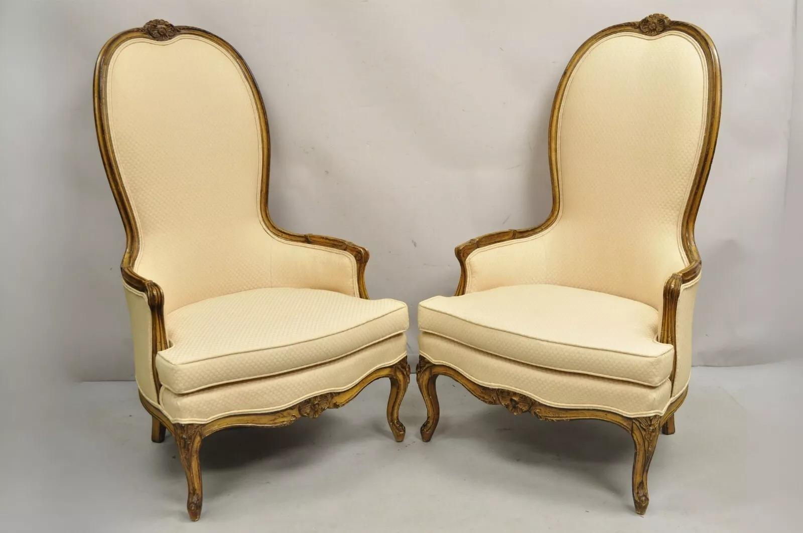 Vintage Hollywood Regency Country French High Back Walnut Lounge Chairs - a Pair. Item features peach colored upholstery distressed two tone finish, tall shapely backs, carved cabriole legs, great style and form. Circa Mid 20th Century.