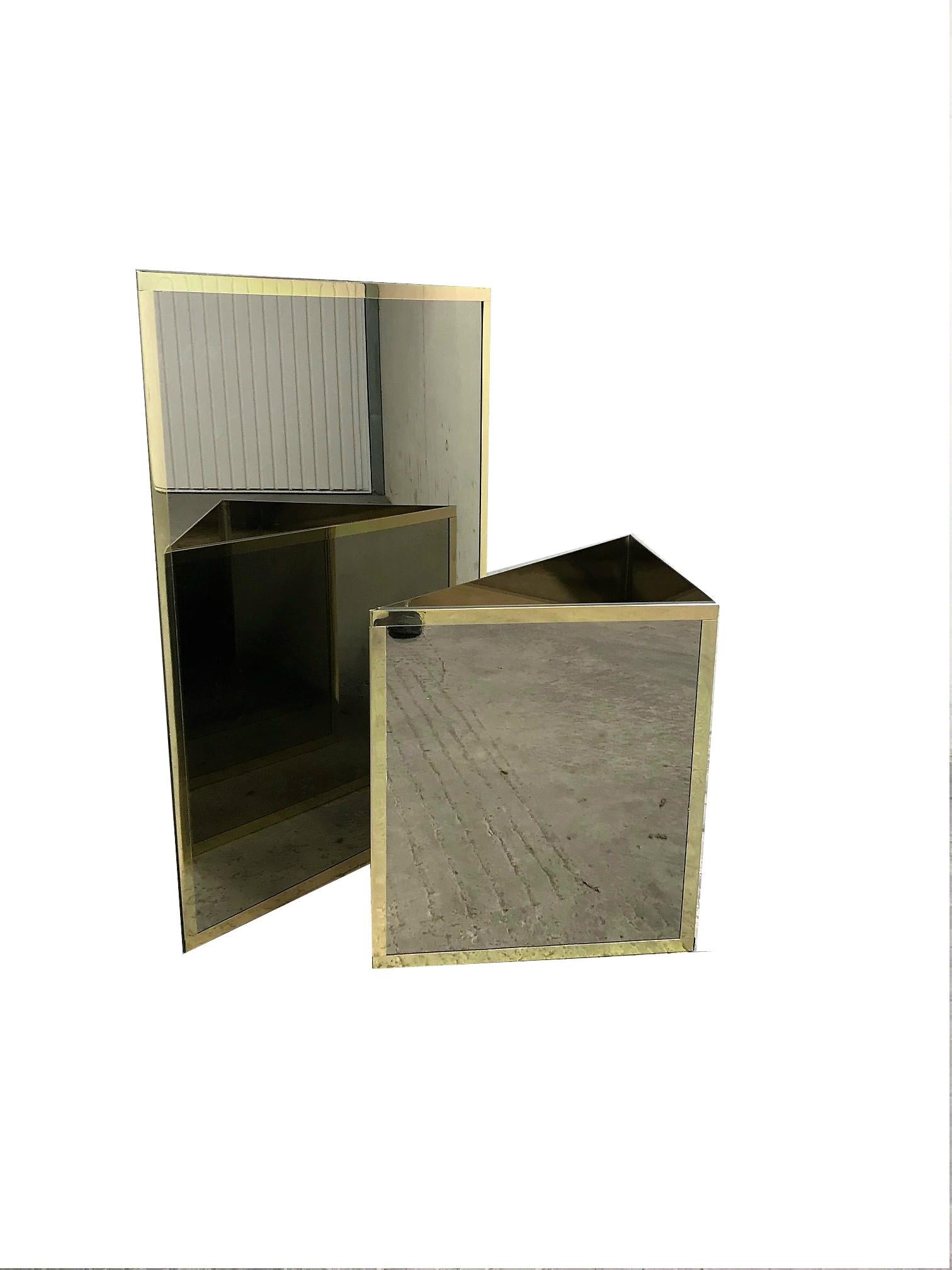 Set of two unique triangular brass and mirrored glass planters.

They where used in a bank in Belgium.

They can be placed together to form a square shaped planter with two levels.

Beautiful statement pieces.

Very good