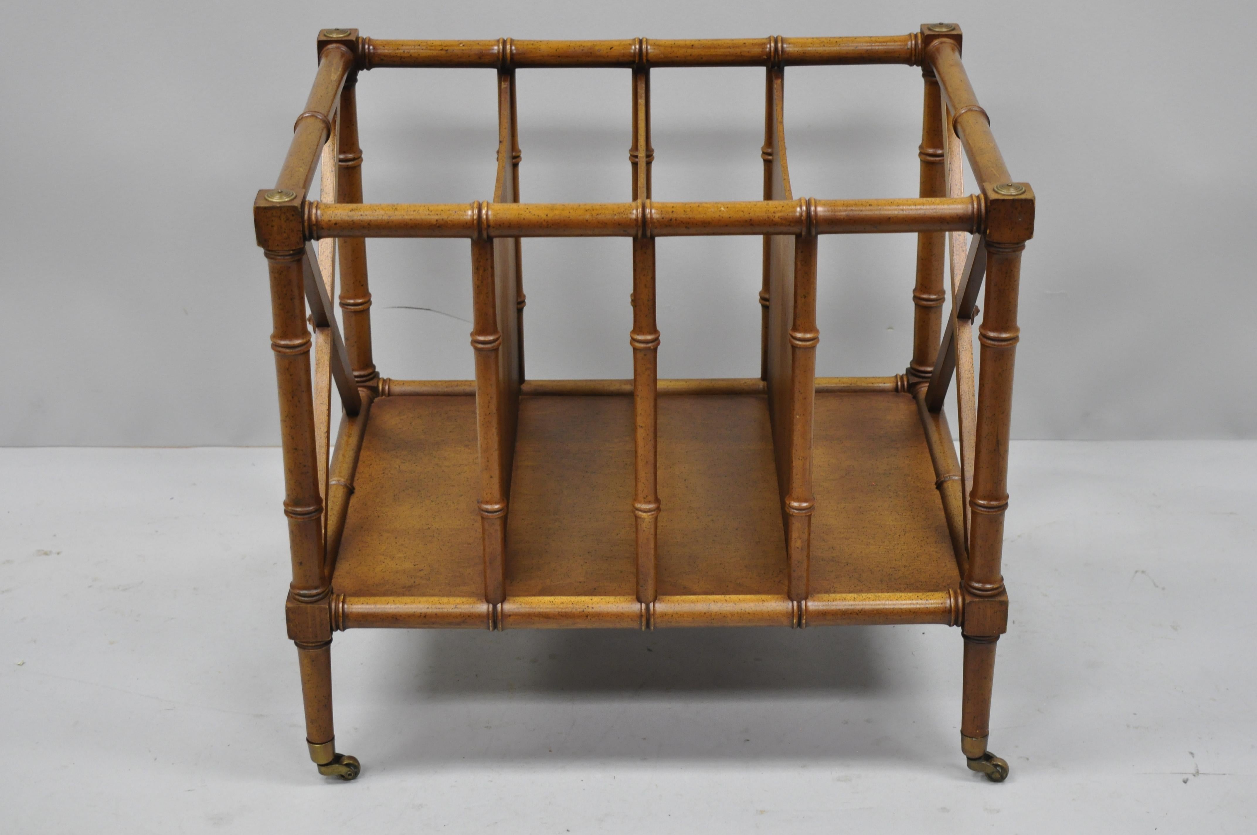 Vintage Hollywood Regency faux bamboo Canterbury magazine rack medallion limited. Item features brass rolling casters, X-form sides, wood construction, original label, great style and form, circa mid-late 20th century. Measurements: 19
