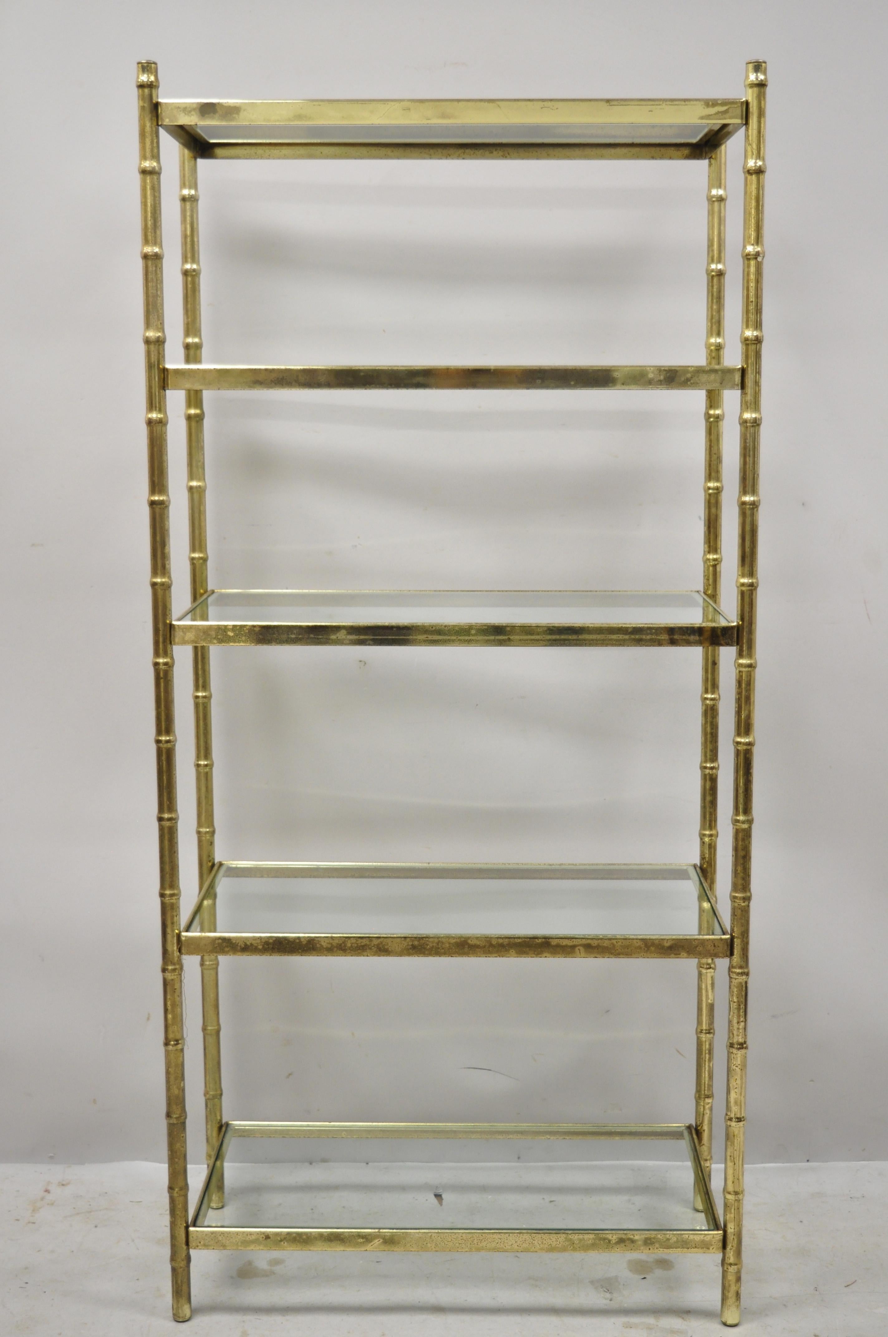 Vintage Hollywood Regency faux bamboo gold metal étagère bookshelf shelf stand. Item features faux bamboo metal frame, glass shelves, very nice vintage item, great style and form, circa mid to late 20th century. Measurements: 56.25