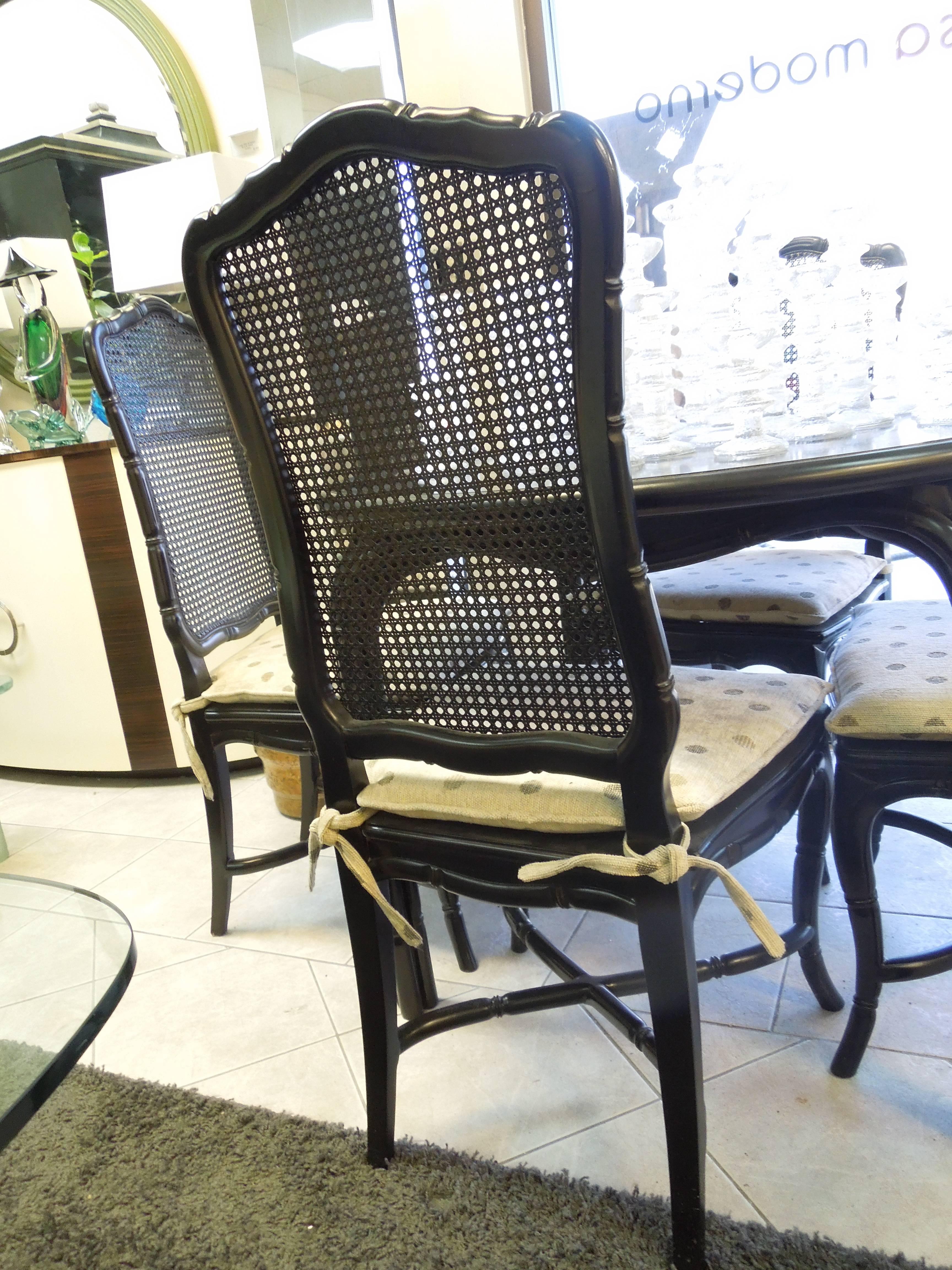 We love this classis but still very modern set. It can be used as a game table or as a dining room set for four. This all original color satin black set came from a very upscale Palm Springs area Country Club  Estate. Caned back and seat, the set