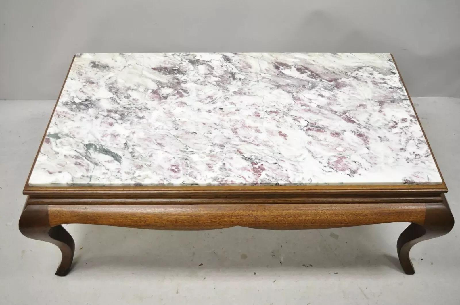 Vintage Hollywood Regency Georgian Mahogany Saber Leg Marble Top Coffee Table. Item features a stunning marble top with pink and purple veins, solid wood frame, beautiful wood grain, shapely cabriole legs, quality American craftsmanship, great style