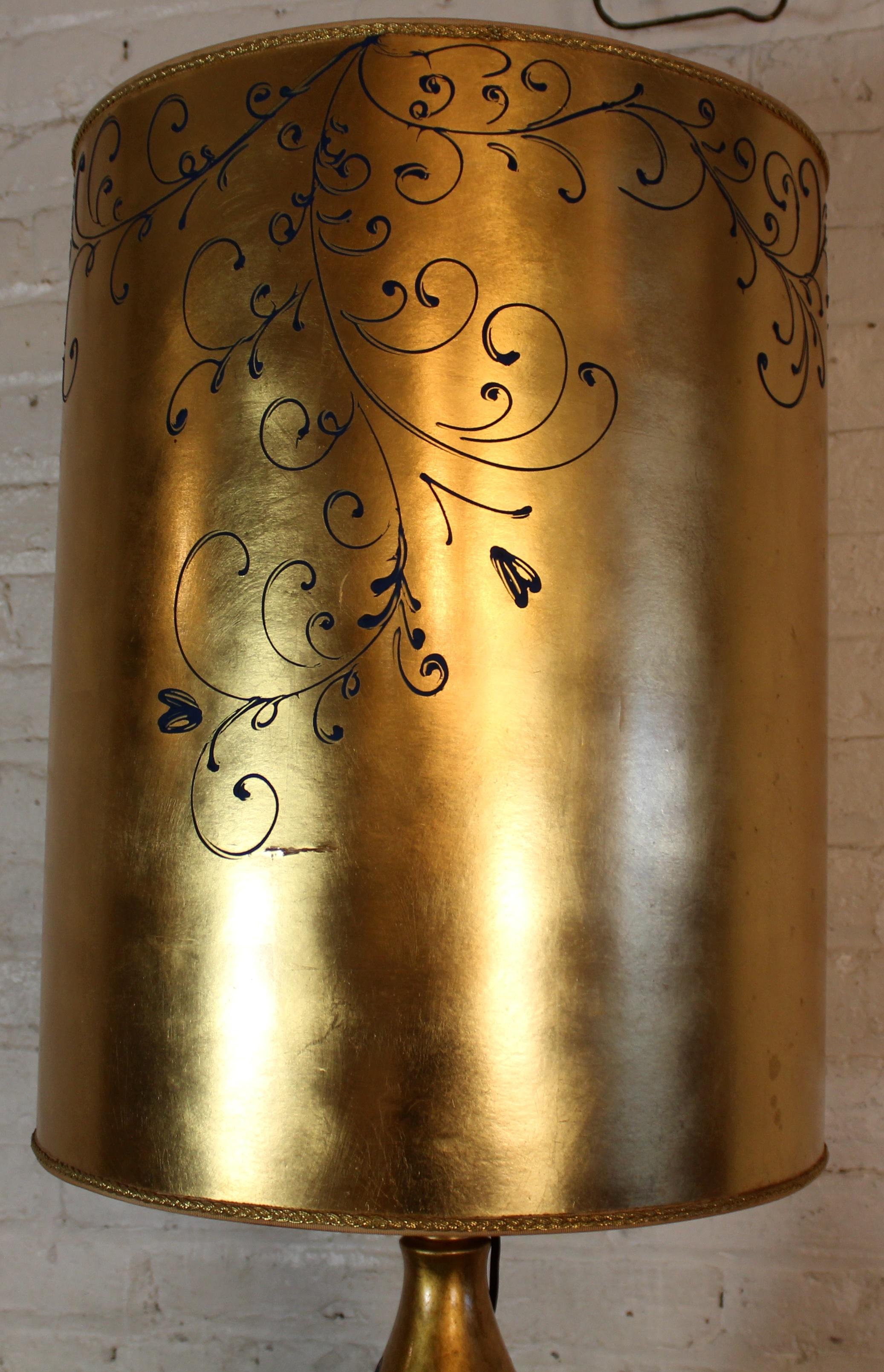 A striking example of Hollywood Regency design, this gourd-shaped table lamp features a richly gilted finish that adds warmth and glamour. The elegant, sculptural form makes it a bold statement piece, well-suited for a variety of interior styles