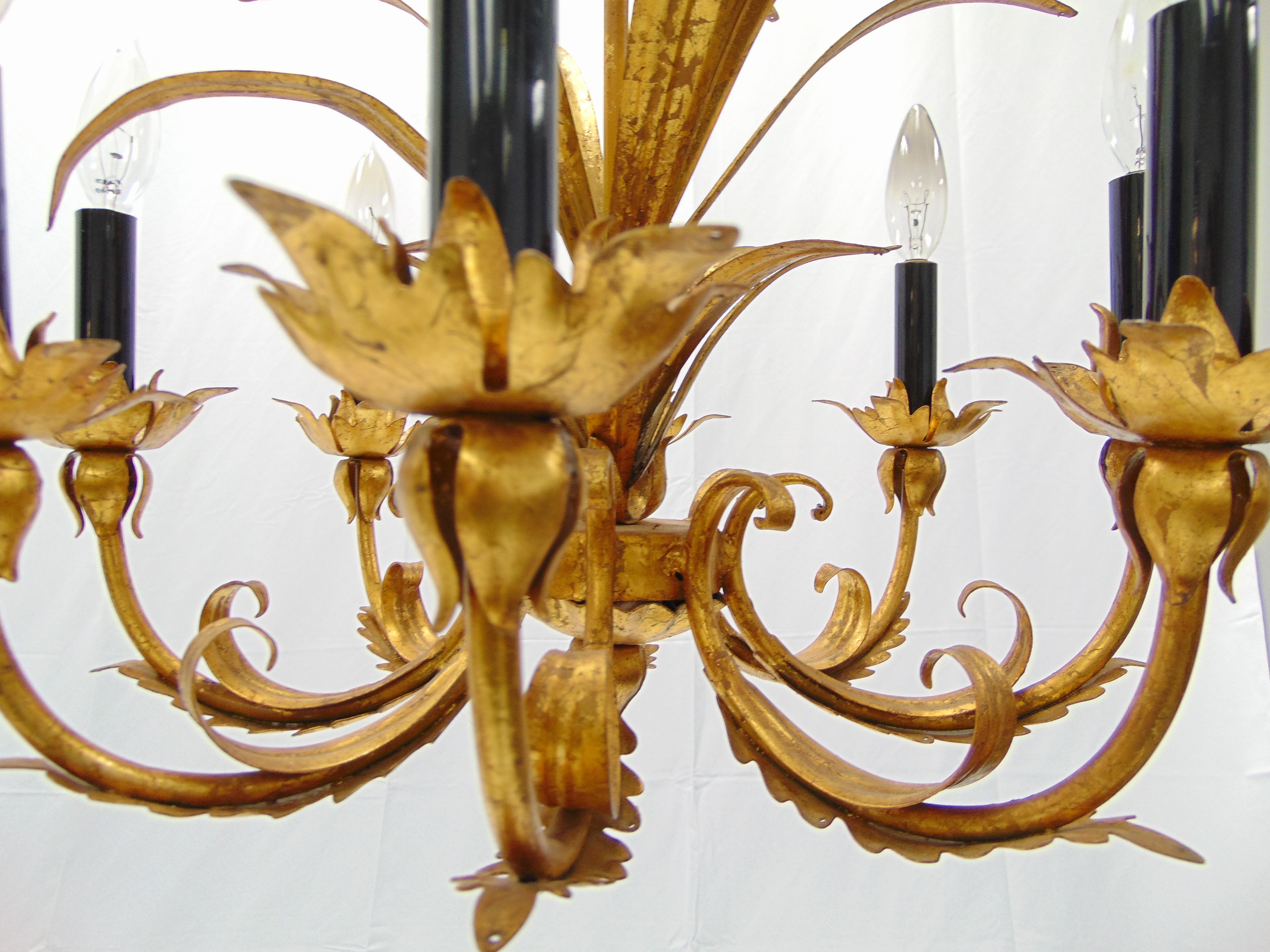 This is a beautiful vintage 1960s Hollywood Regency gold gilt chandelier. It holds 8 lights. The dimensions are: 23