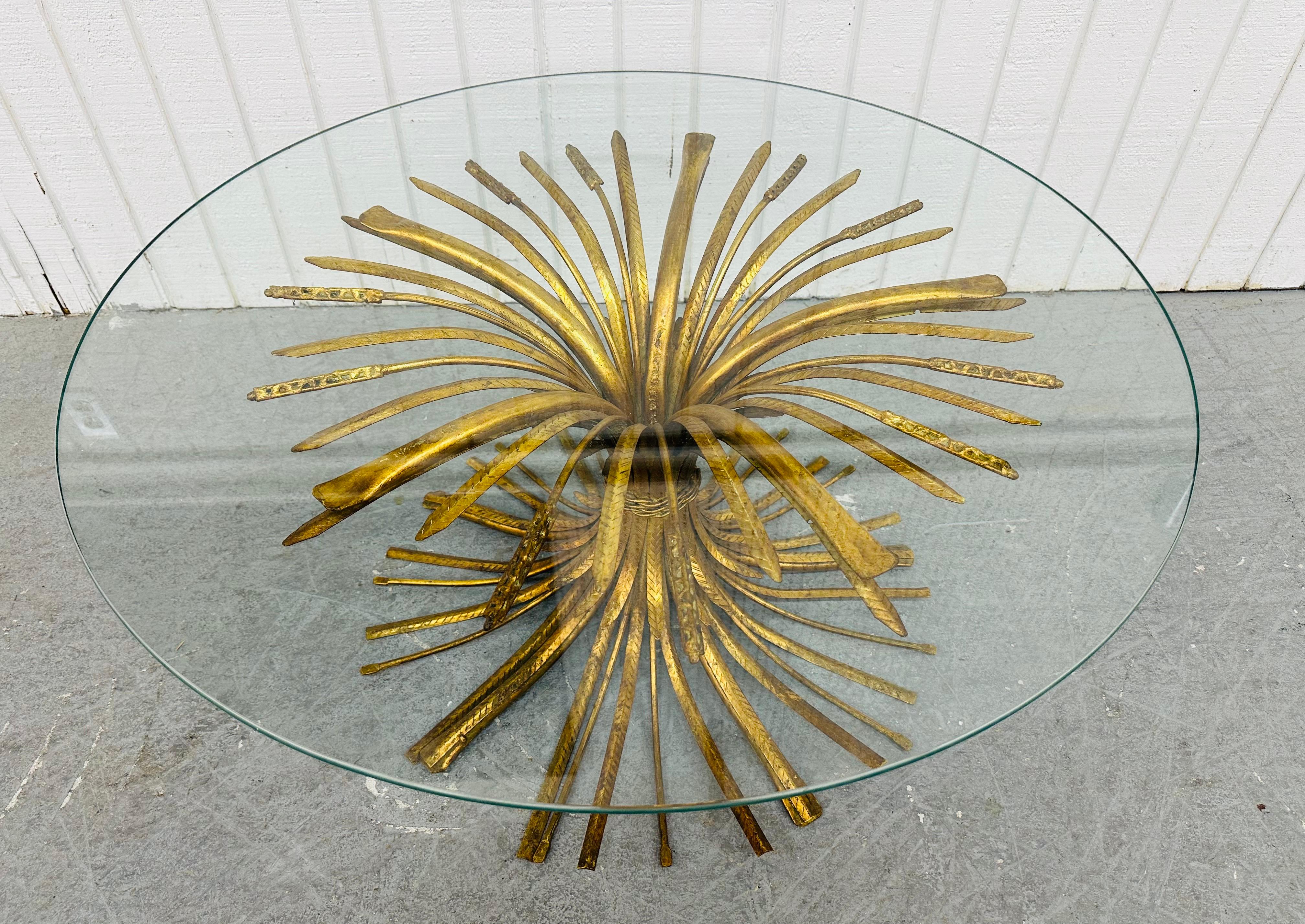 This listing is for a Vintage Hollywood Regency Gold Gilt Wheat Glass Top Coffee Table. Featuring a round glass top, sheaf of wheat metal base, and a beautiful gold gilt finish. This is an exceptional combination of quality and design!