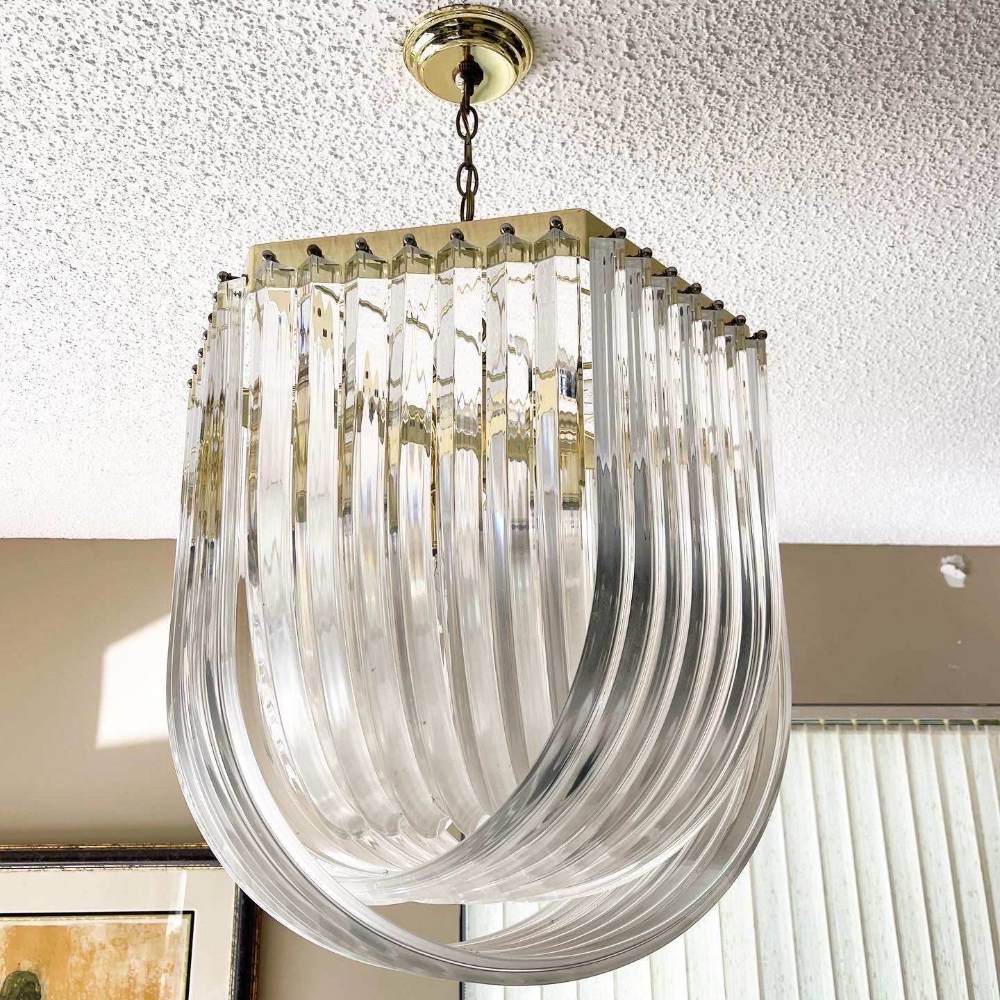 American Vintage Hollywood Regency Gold Lucite Ribbon Lucite Chandelier For Sale