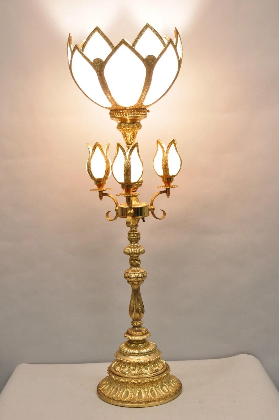 Please message us with your zip code to request a more reasonable domestic U.S. shipping quote.

Vintage Hollywood Regency Gold Tall Candlestick Lantern Tulip Table Lamp with White Slag Glass Shades. Circa Late 20th Century. Measurements: 44.5