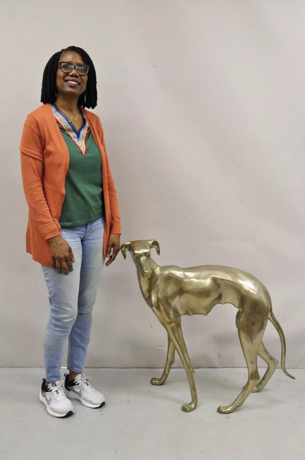 Vintage Hollywood Regency Life Size Brass Greyhound Whippet Dog Statue Sculpture. Approx 30 lbs. Circa Mid 20th Century. Measurements: 32