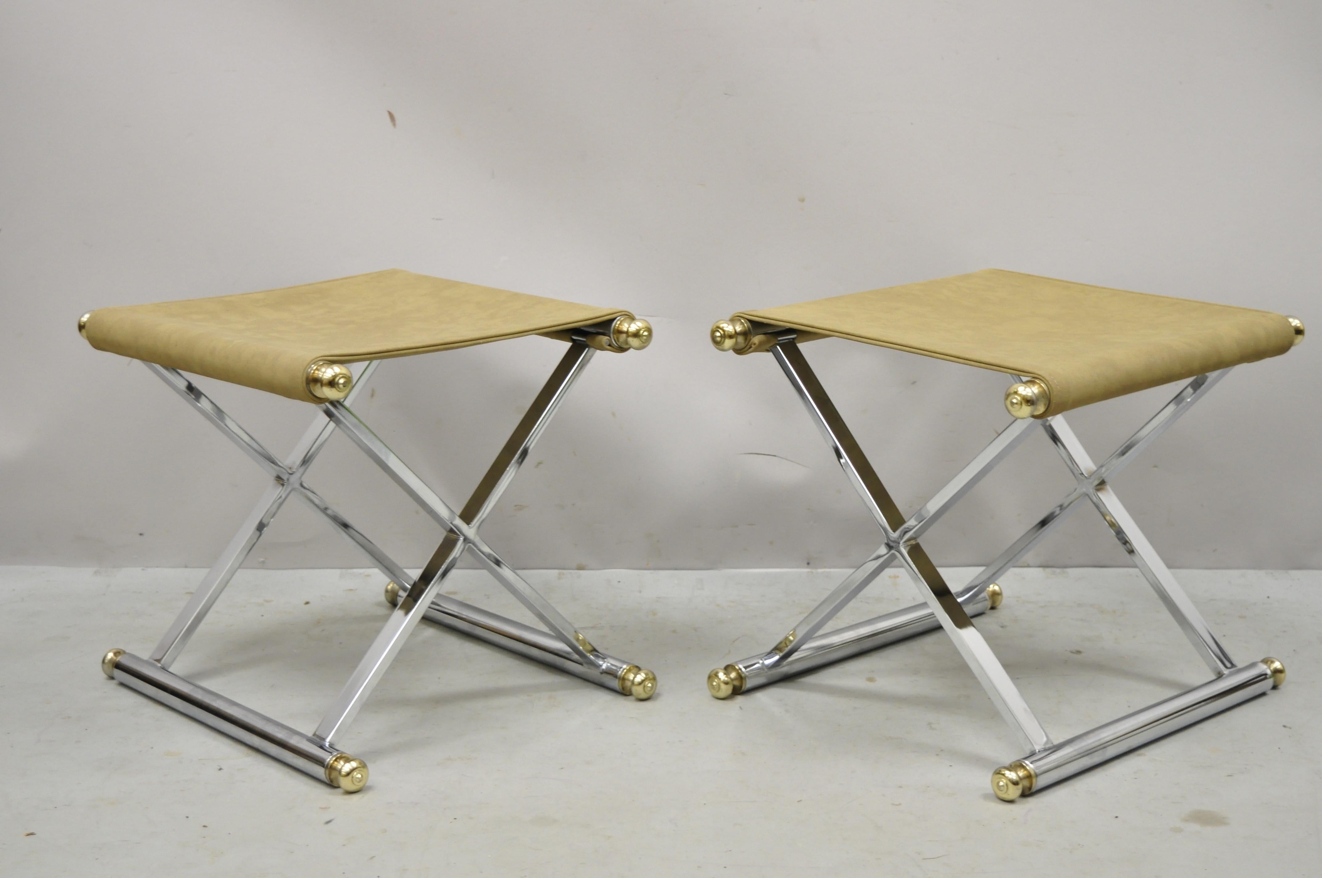 Vintage Hollywood Regency Maison Janson Style Chrome X-Frame modern stools - a Pair. Item features chrome X-Frame, brass accents, upholstered sling seat, very nice vintage item, great style and form. Circa 1970s. Measurements: 15.5