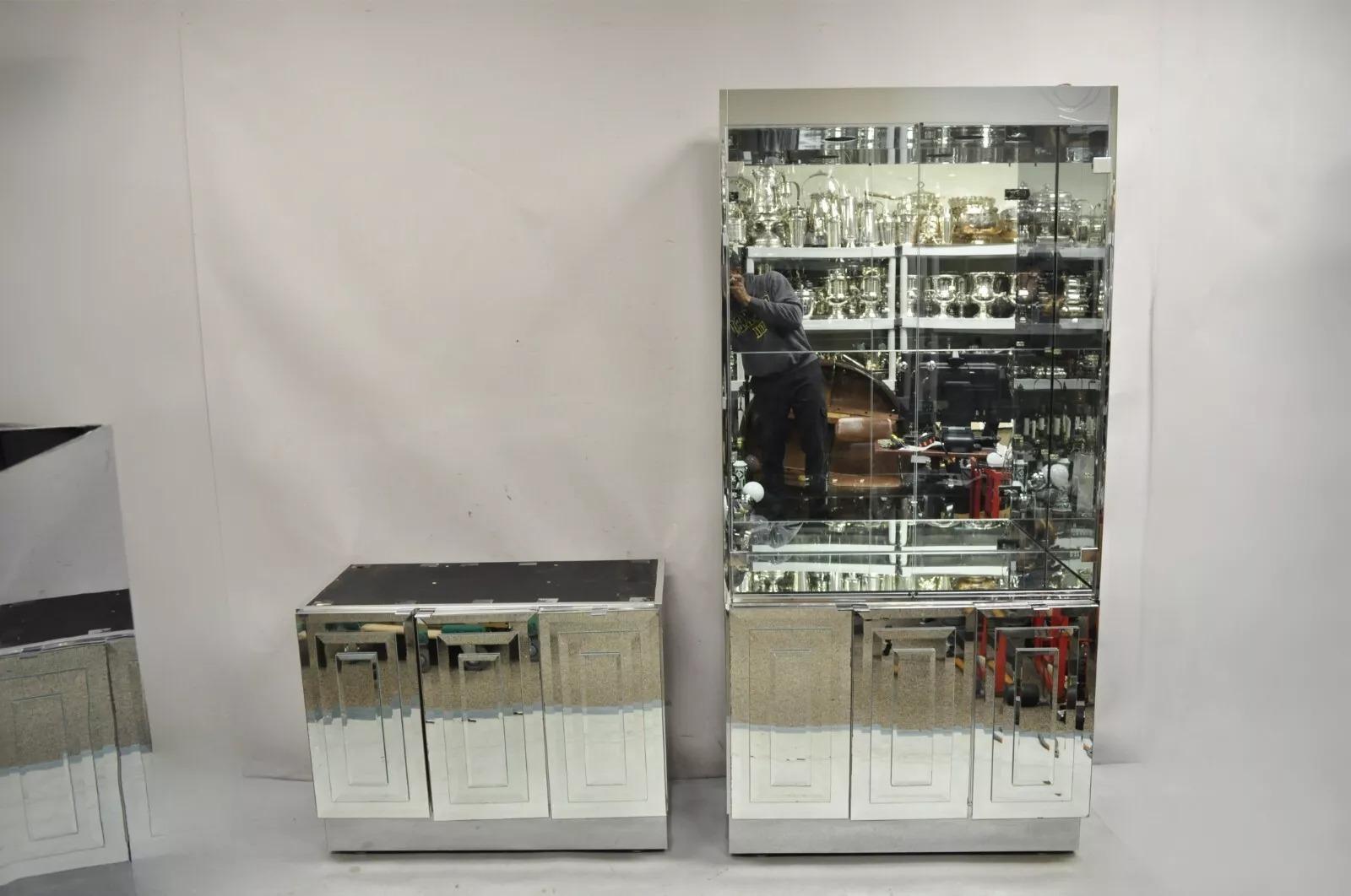 Vintage Hollywood Regency Mirrored Credenza Display Cabinets by Ello - a Pair. Listing includes (2) cabinets with lighted interiors, metallic case, glass mirror front and backs, glass shelves, clean Modernist lines. Each cabinet separates into (2)