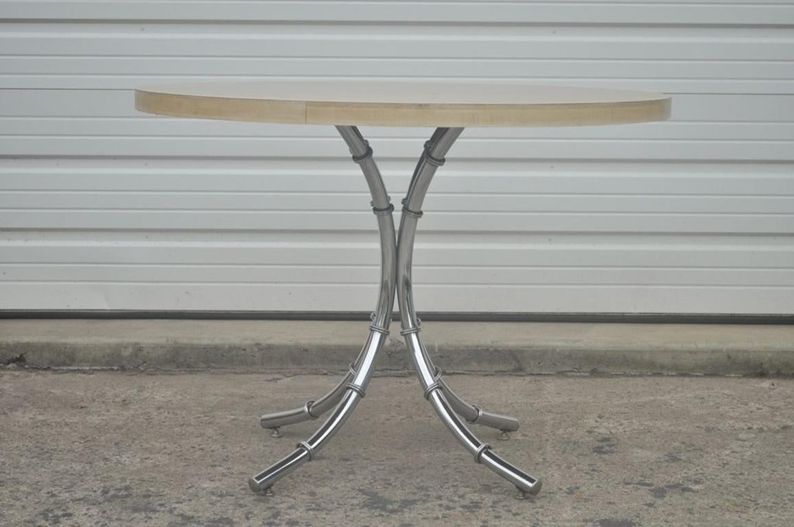 Hollywood Regency chrome faux bamboo dining set consisting of laminate top table and four side chairs, circa mid-20th century.
Measurements: Table 30.75