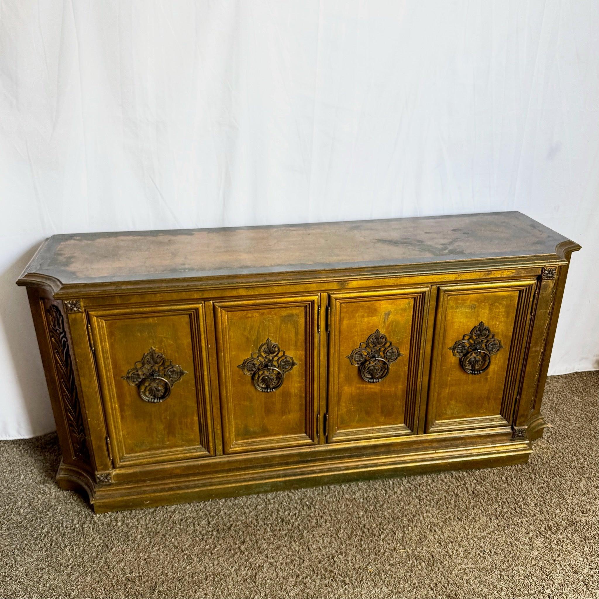 Vintage Hollywood Regency Gold Credenza—striking gold finish with ornate detailing offers opulent glamour and functional storage.
 
 Some wear to the finish as can be seen in the photos. 
 
 We sell items as acquired, without restoring or repairing.