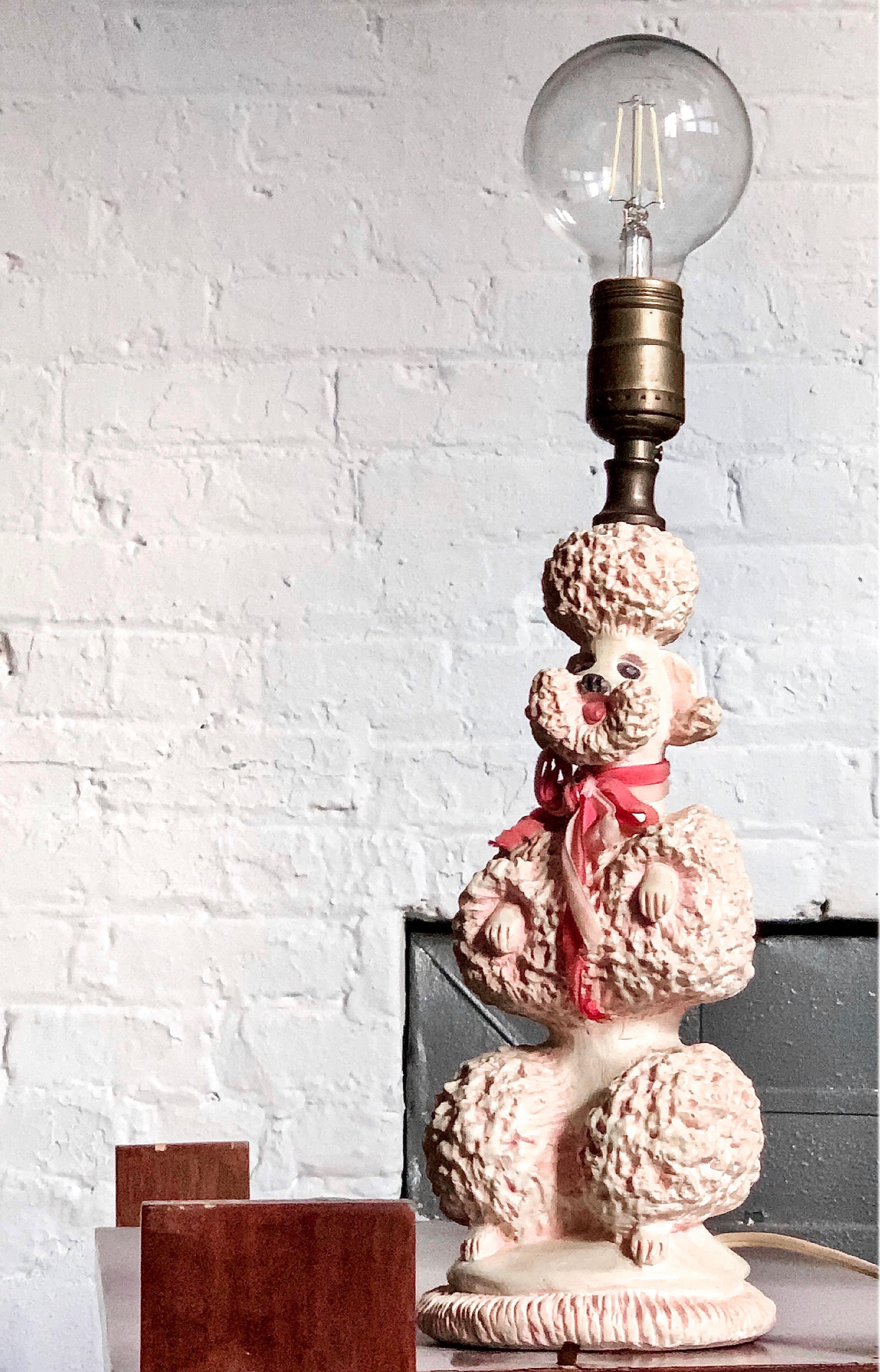 Vintage Hollywood Regency Phyllis Morris pink toy poodle table lamp, 1952.

Phyllis Morris’ first and most iconic design was the poodle lamp, circa 1952, which she often delivered to clients personally in her pink Cadillac convertible. After