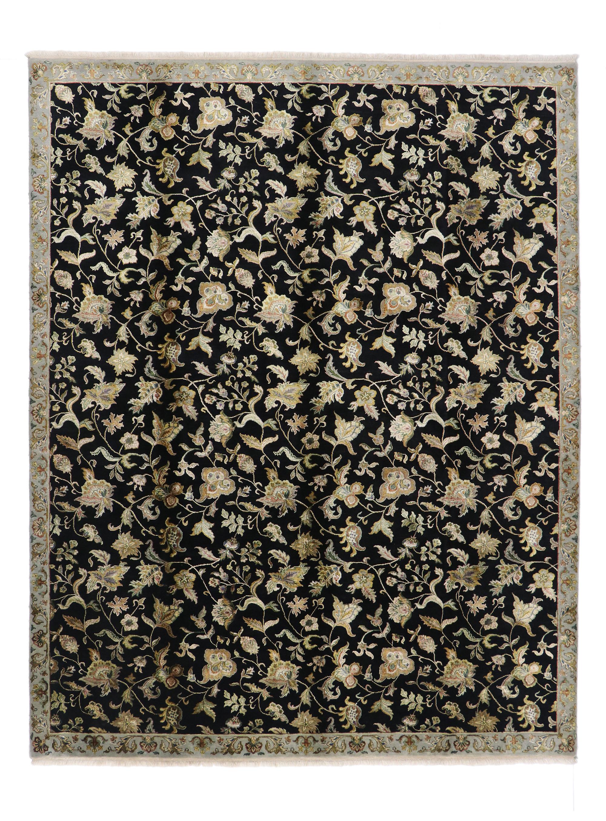76873, vintage Hollywood Regency style area rug. Striking and eclectic, this hand knotted wool vintage Indian rug features the deep black and gold colorway of the Hollywood Regency style. An all-over pattern of undulating tendrils and florals covers