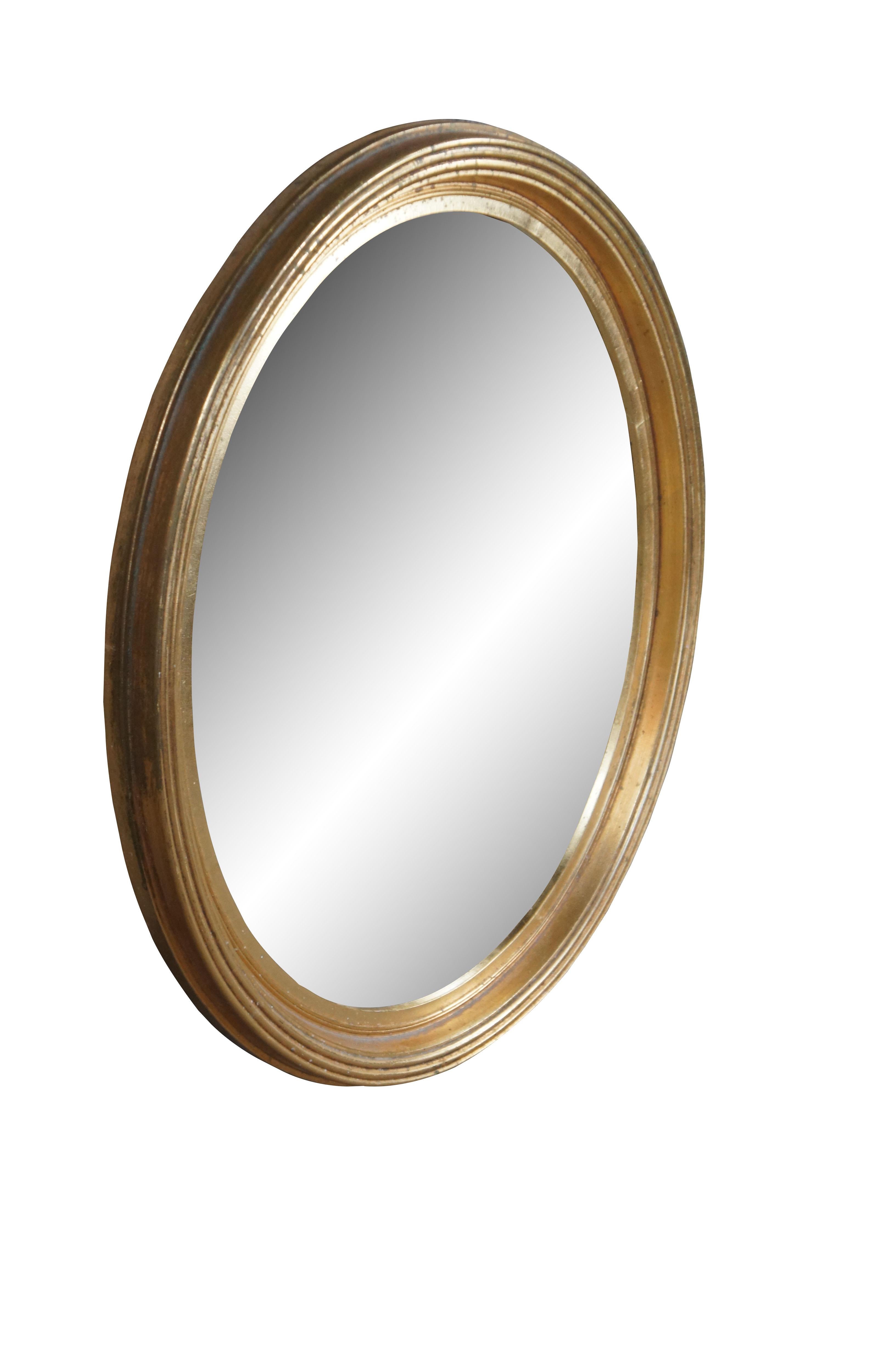 Vintage Hollywood Regency Style Gold Oval Wall Hanging Vanity Bathroom Mirror.  Features a wooden framed finished in gold plate (mirrored) glass.

Dimensions:
21