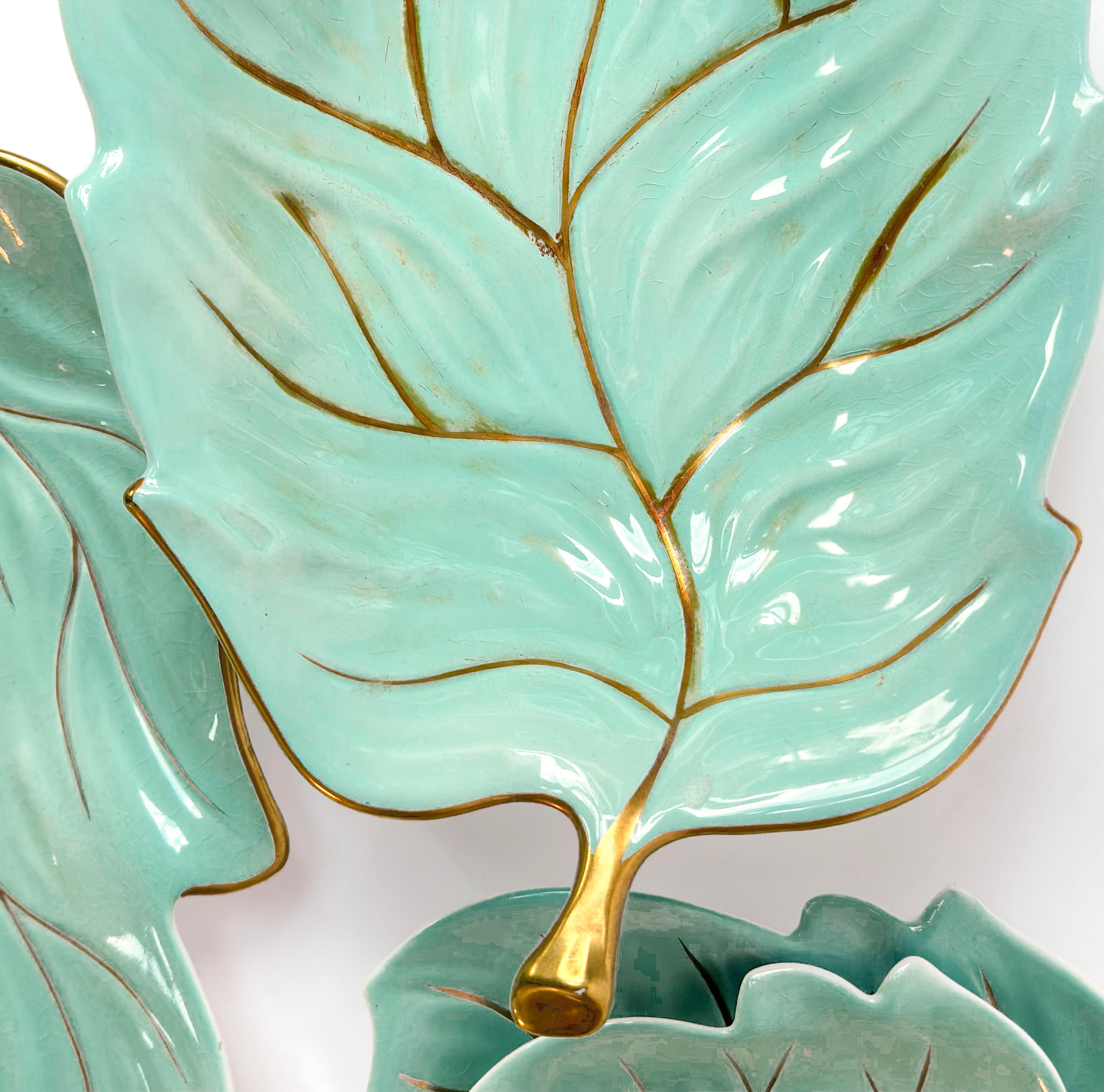 Set of 4 Hollywood Regency style plates 

 This collection features four leaf-shaped serving plates by the renowned English pottery manufacturer, Carlton Ware. Crafted from fine English porcelain, each piece is glazed in a striking turquoise hue,