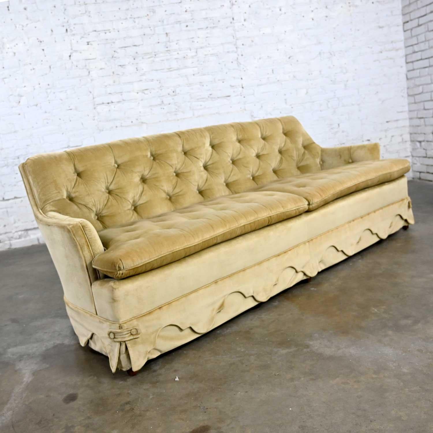 Wonderful vintage Hollywood Regency style tawny-colored button tufted velvet sofa by Heritage. Beautiful condition, keeping in mind that this is vintage and not new so will have signs of use and wear. It has been professionally shampooed and several