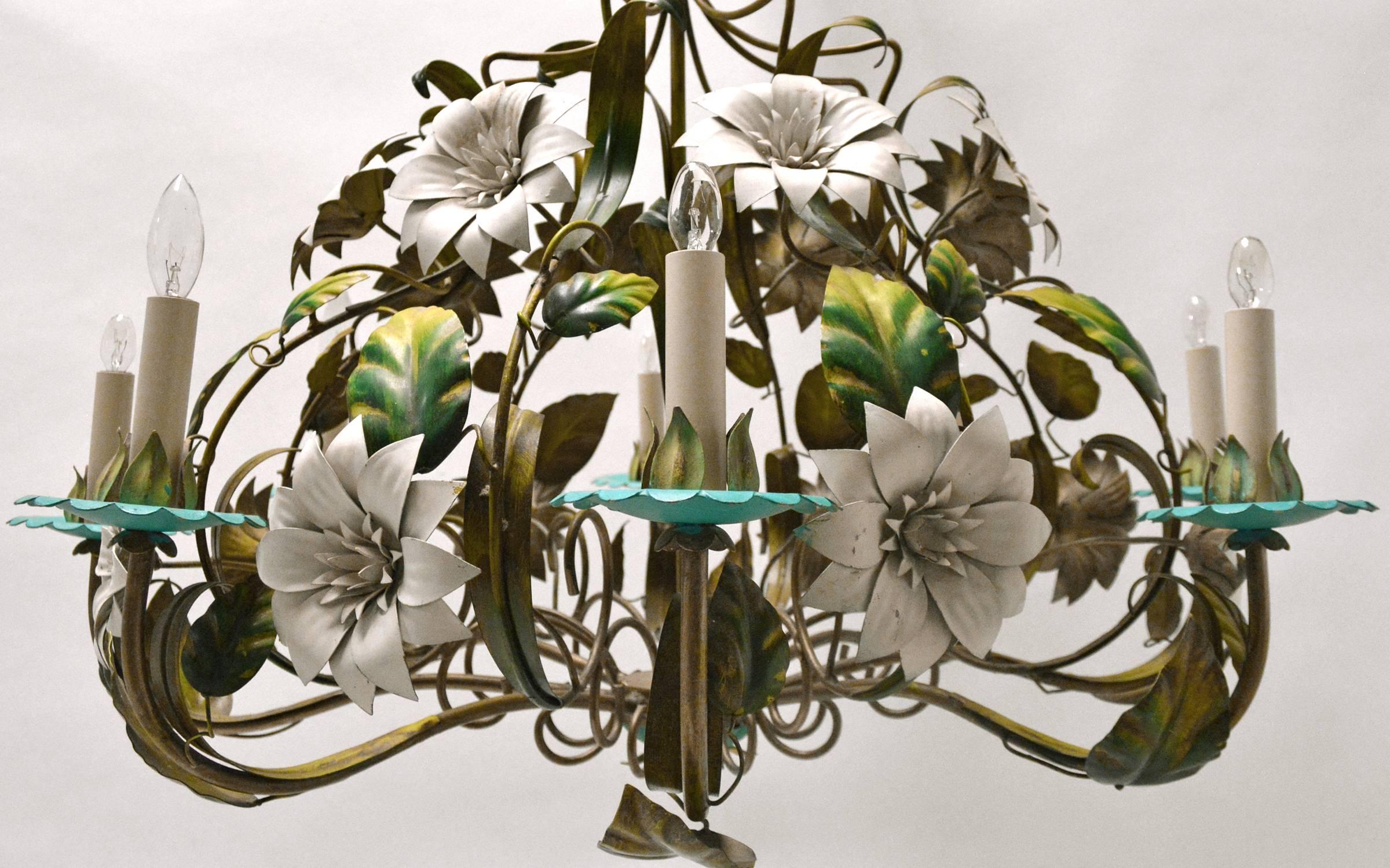 A large vintage tole eight-light chandelier with flower and leaf accents. Original paint finish in vibrant greens, turquoise and white.