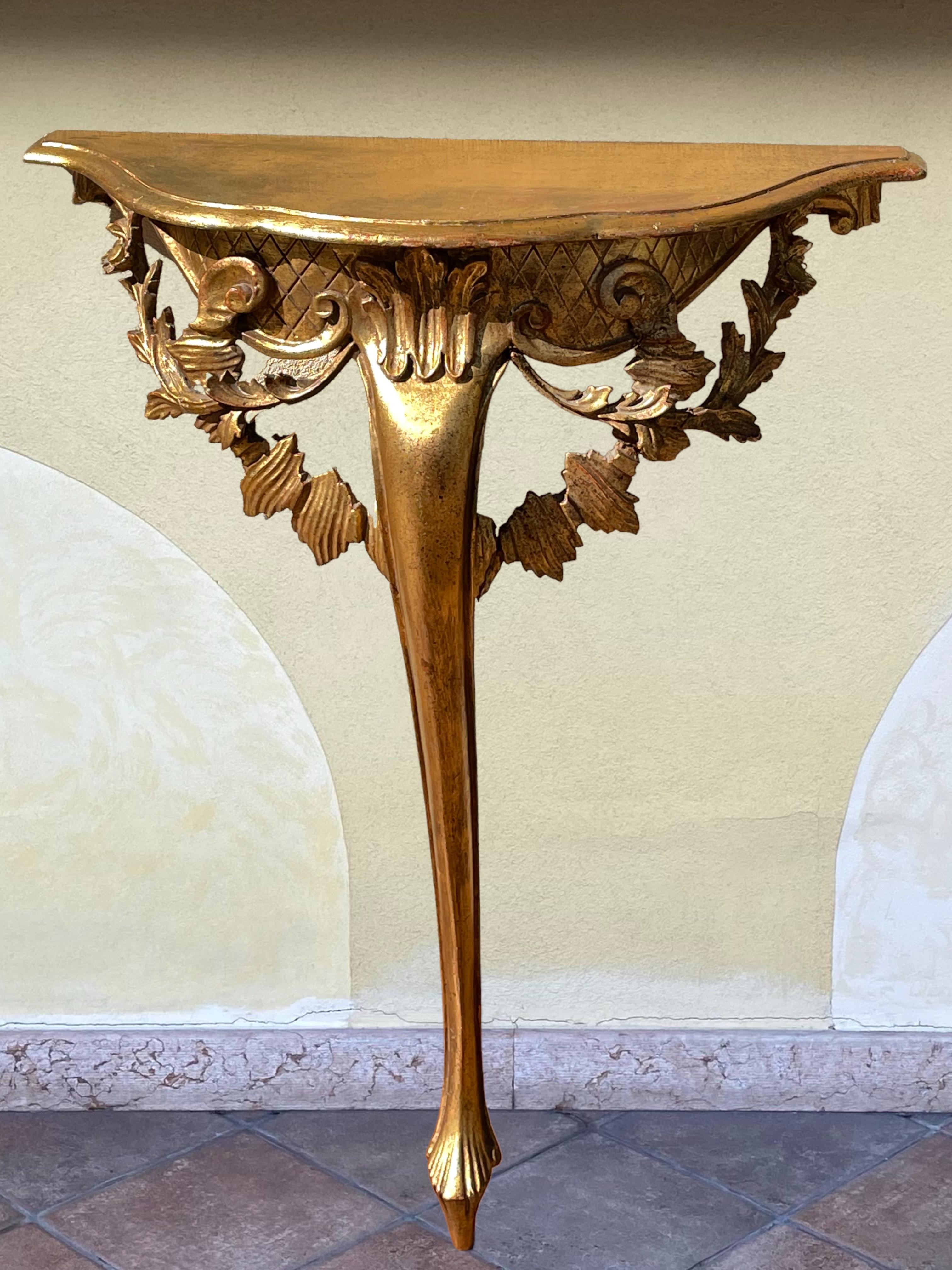 Offered is an absolutely stunning, 1920s Italian gilt wood wall console table. Minor patina gives this piece a classy statement. Made of hand carved wood and gilded. A nice table to present a statuette or a beautiful object. A nice addition for your