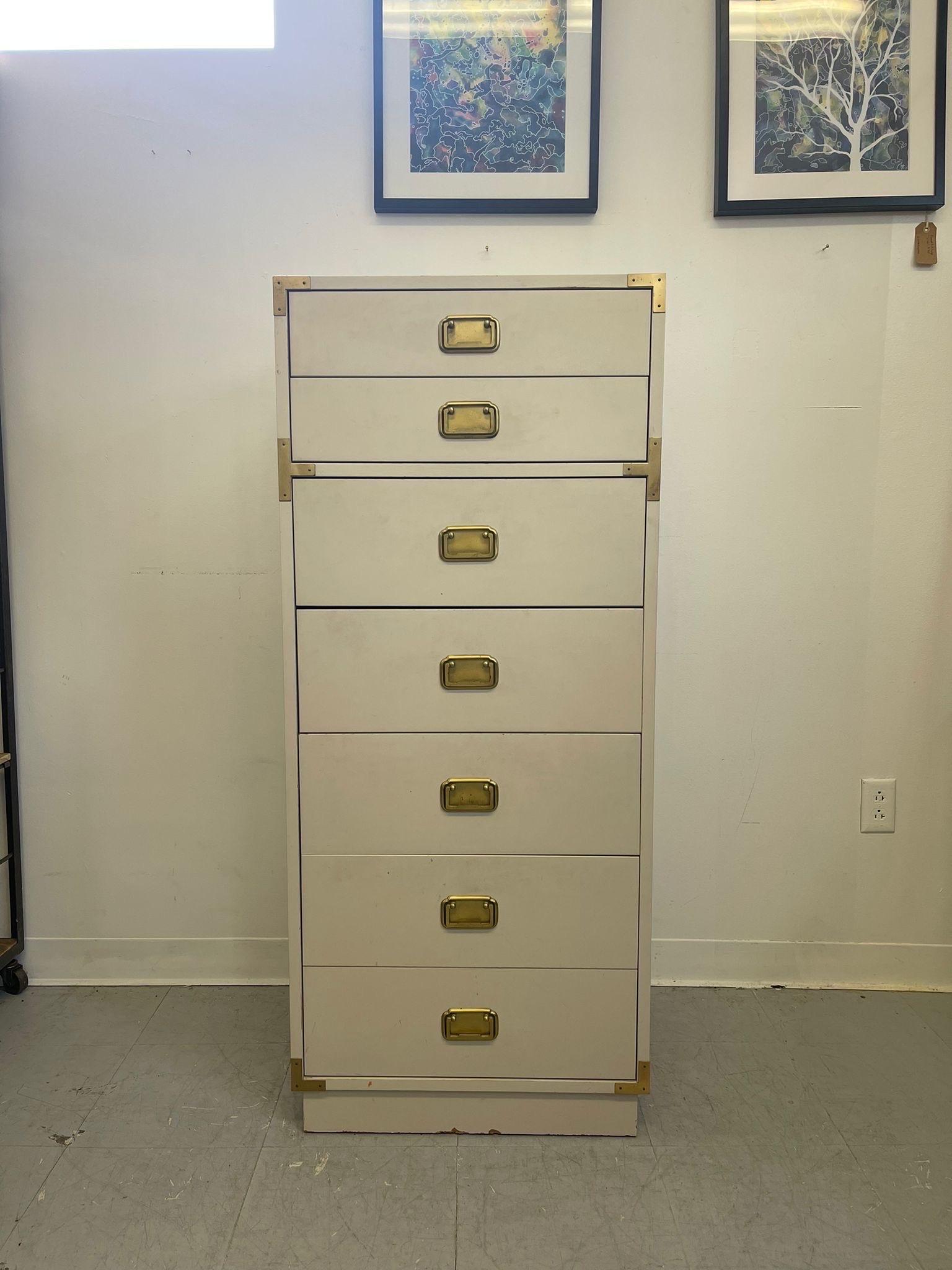 This Dresser Features 7 dovetailed drawers and Classic campaign design. Gold toned hardware. Slight Petina to the paint and hardware. No Makers mark. Vintage Condition Consistent with Age as Pictured 

Dimensions. 22 W ; 16 ; D 52 H