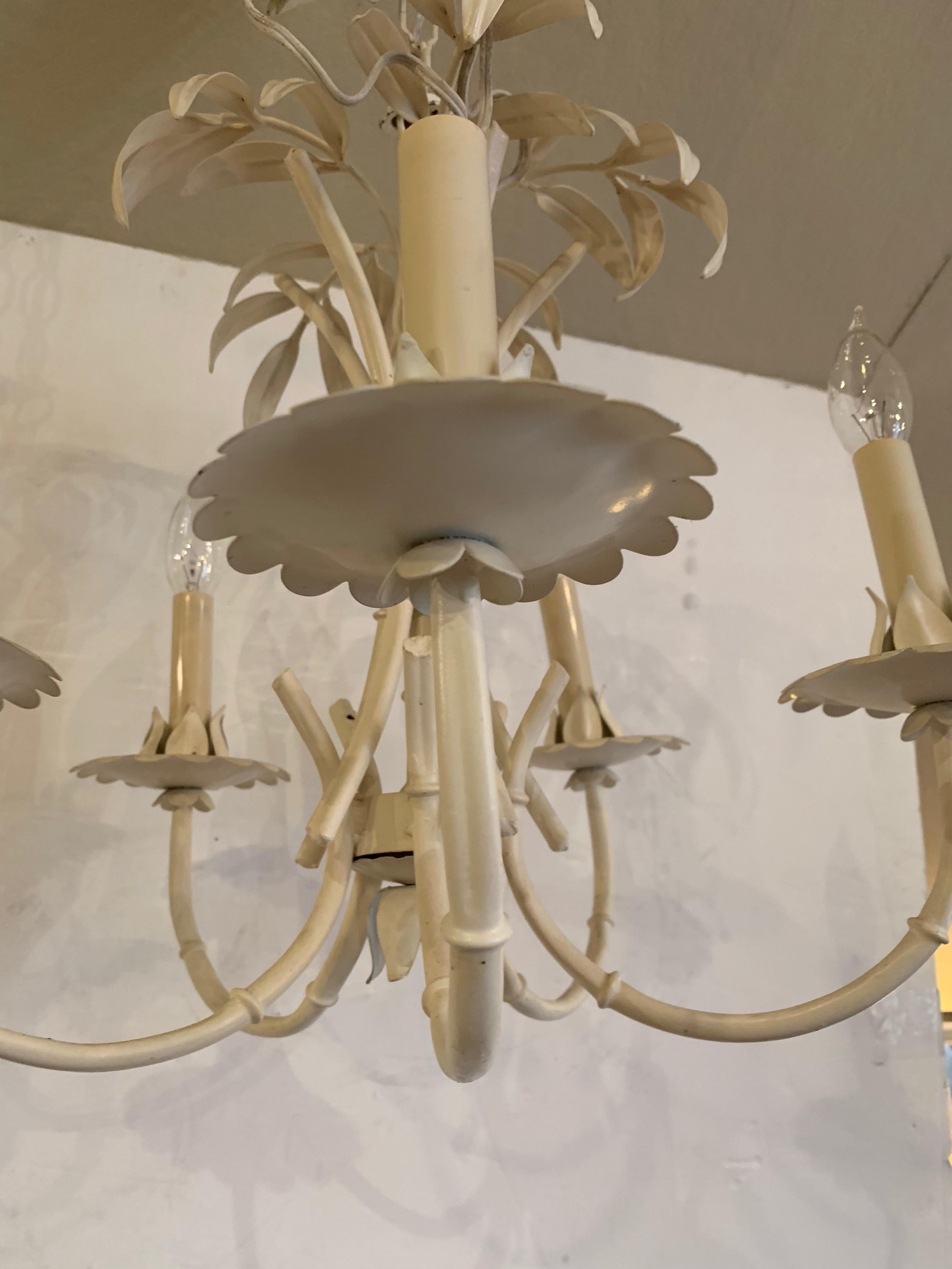 A Classic palm leaf motif chandelier that's faux bamboo iron and tole with 5 arms and original ceiling cap.