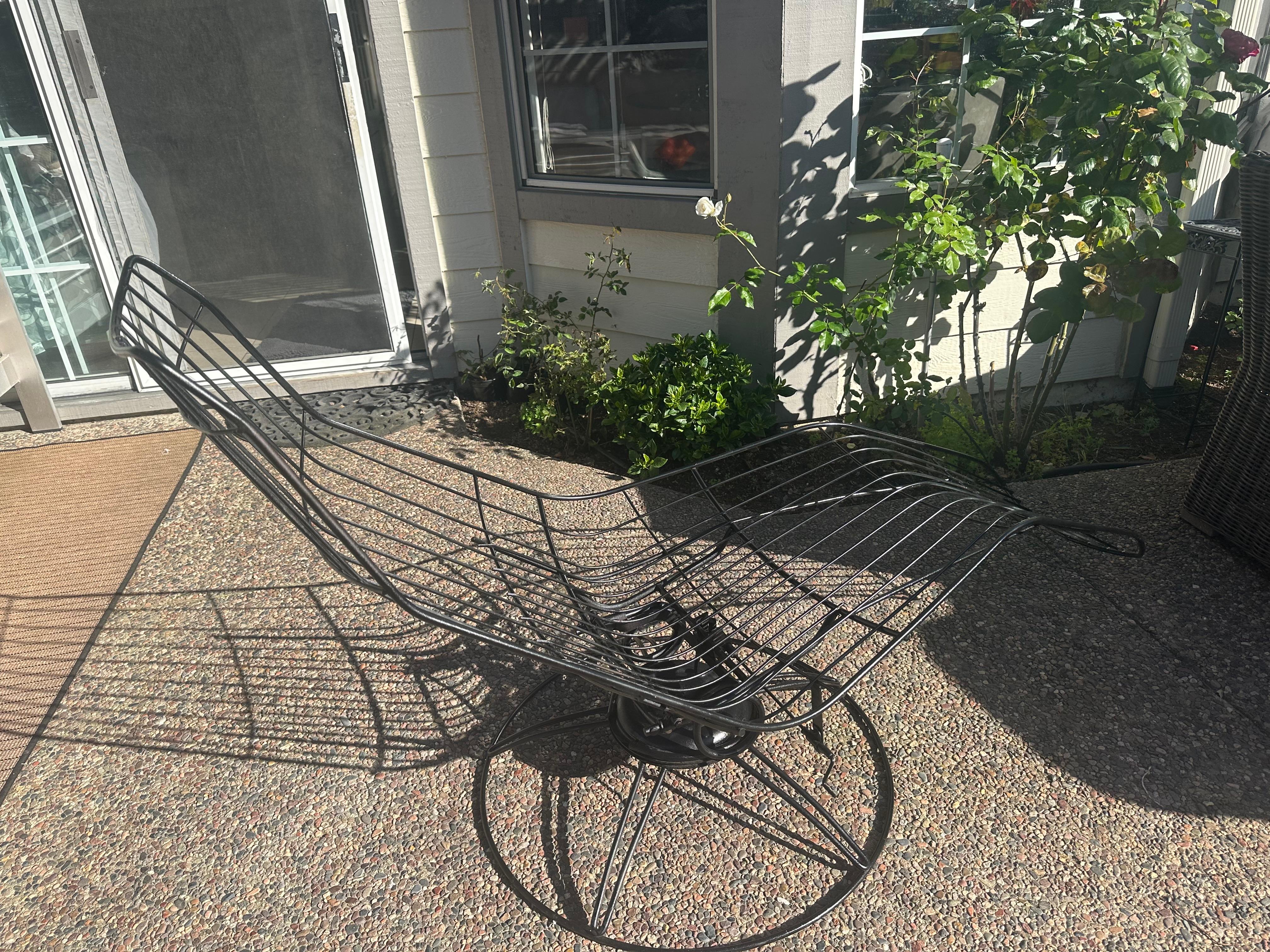Homecrest Siesta Bottemiller banana chaise lounge chair.
Works great still
made of Wrought Iron
it swivels and rocks

just spray painted black

clean modernist lines of wrought iron design and swivel and spring seat, 
No makers mark , tags or