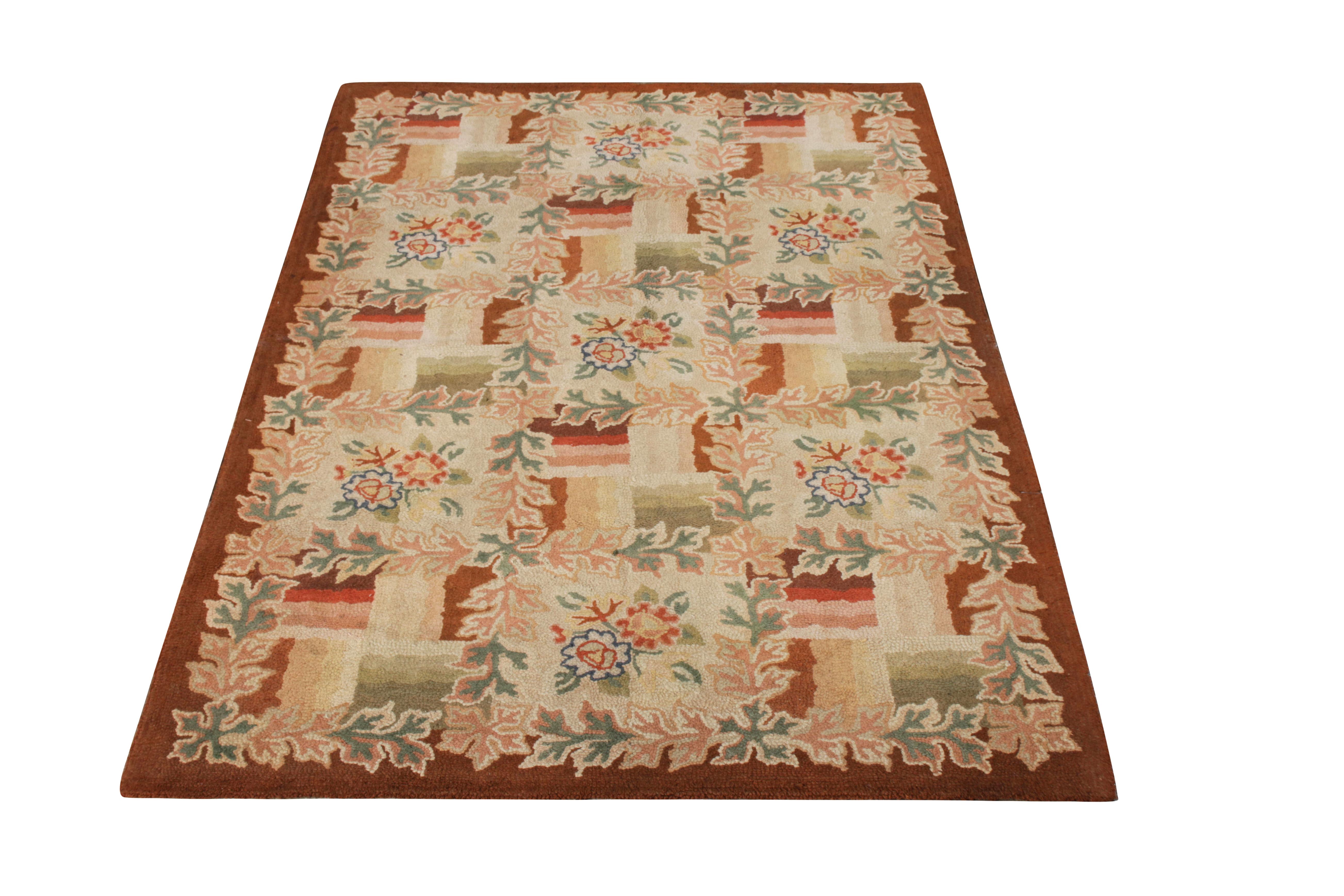 Originating from the United States in the 1950s, this vintage floral rug hails from a premier collection of hand hooked wool carpets, standing out for its use of rich and varied colorways and its sharp, lasting detail in pristine condition. The