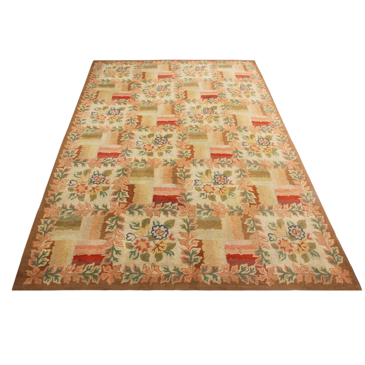 Originating from the United States in the 1950s, this vintage floral rug hails from a premier collection of hand hooked wool carpets, standing out for its use of rich and varied colorways and its sharp, lasting detail in pristine condition. The