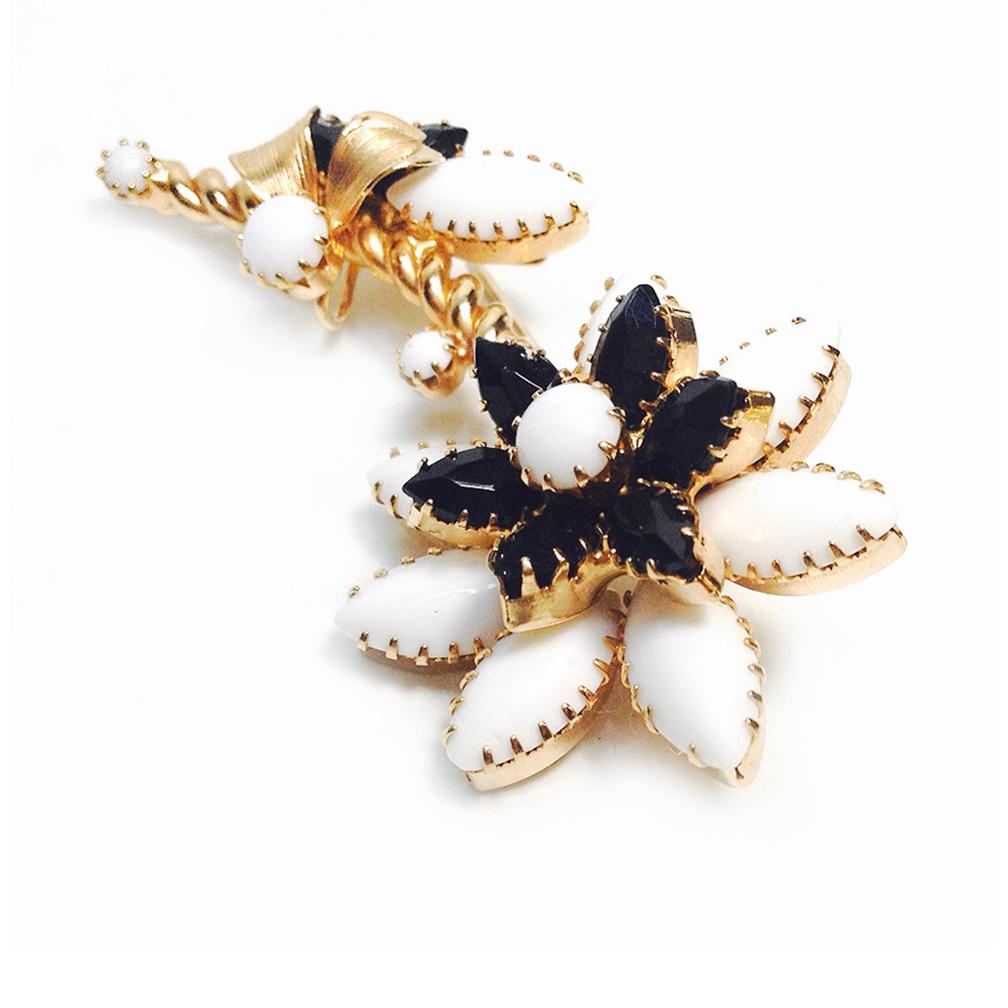 This is a Demi-parure of vintage Hope Chest flower brooch and clip back earrings. It's well made with dog-tooth prong set milk glass and accented with some black glass marquise-cut stones as flower petals and signed Hope Chest on the copper backs.