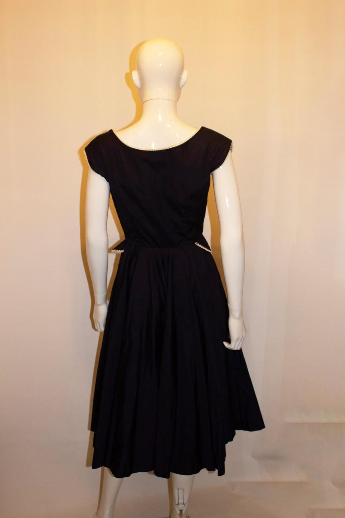 A great vintage day dress by  Horrockses.  The dress is in blue cotton with white detail. It has a wonderful flared skirt, great for dancing,  side zip opening, boat neckline and detail at the waist. 
Size 12 , Measurements: Bust 36'', waist 25'',