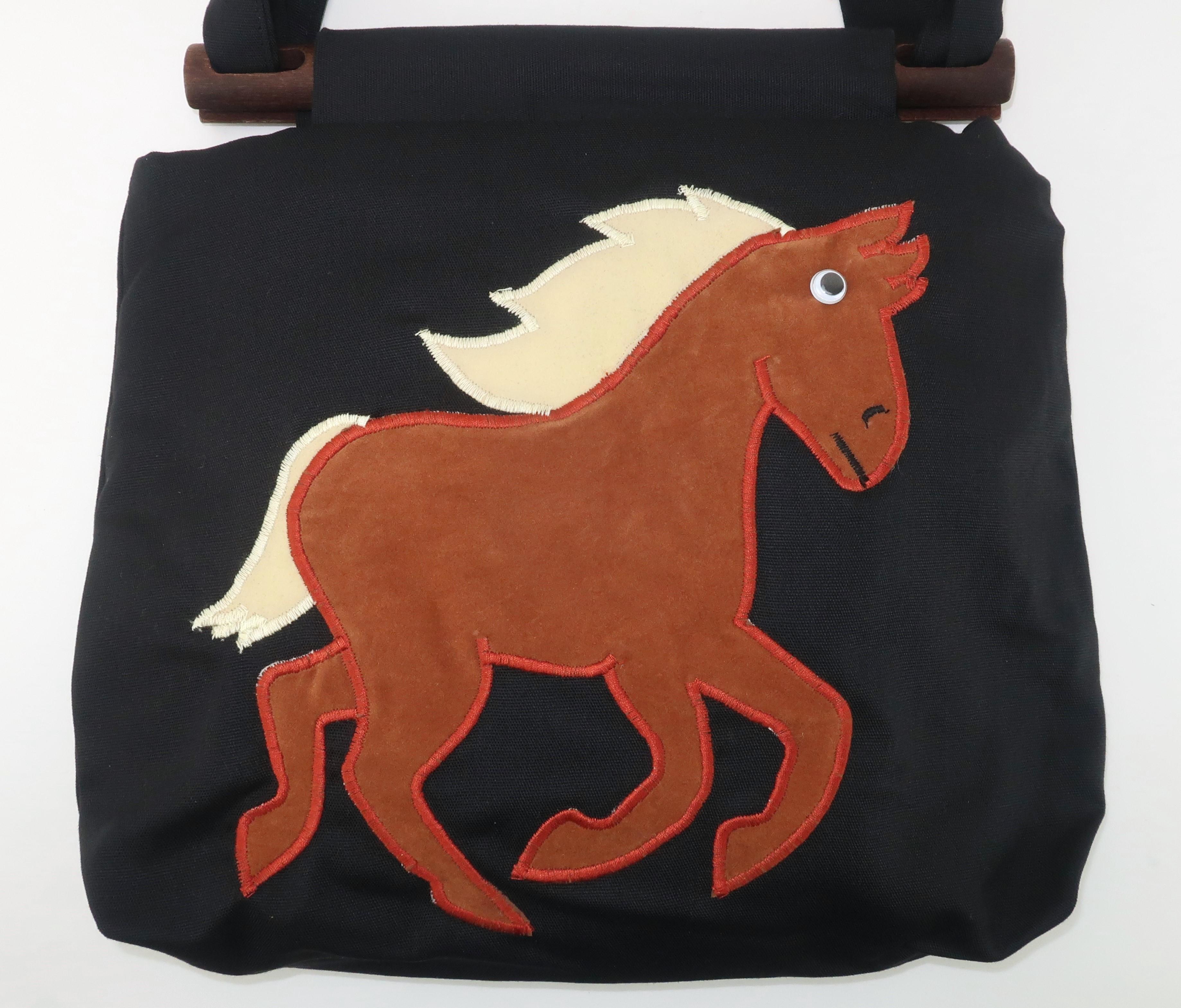 Wonderfully whimsical tote style handbag accented by a horse applique complete with 'googly' eye silliness.  The bag is constructed in a black canvas lined with a quilted black and white floral cotton.  The horse applique is a brown and creme ultra