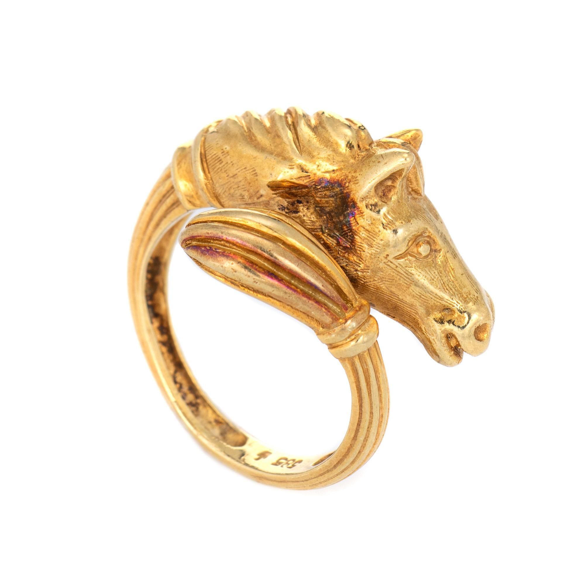 Stylish vintage Horse ring (circa 1960s to 1970s) crafted in 14 karat yellow gold. 

The finely detailed ring features the head of a horse with textured detail to the mane. The tail wraps around the finger. The medium rise ring (9.5mm - 0.37 inches)