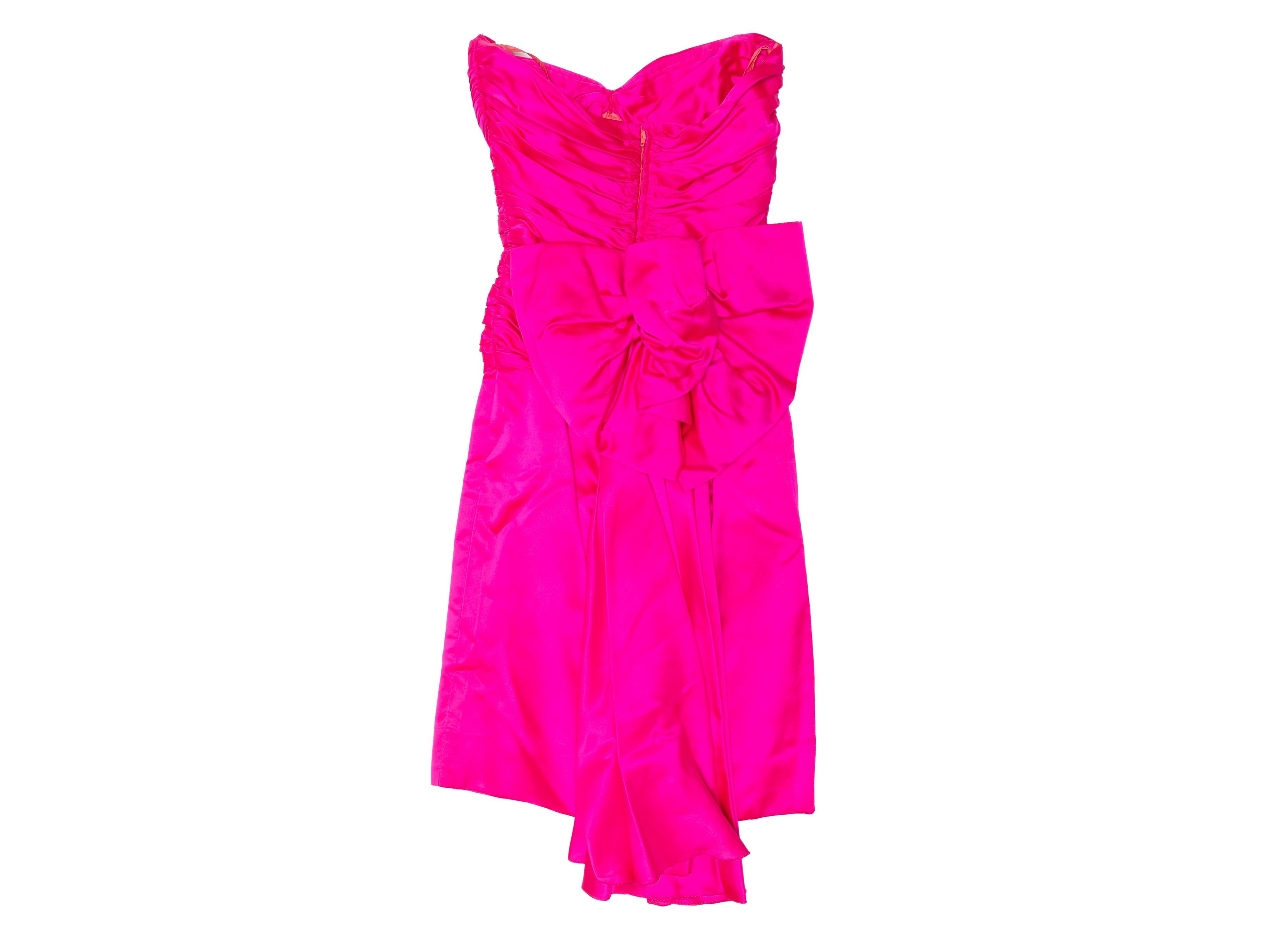 Vintage hot pink silk strapless party dress by Vicky Tiel. Circa 1980s. Sweetheart neckline. Oversized bow at back. Zip closure at center back. 26