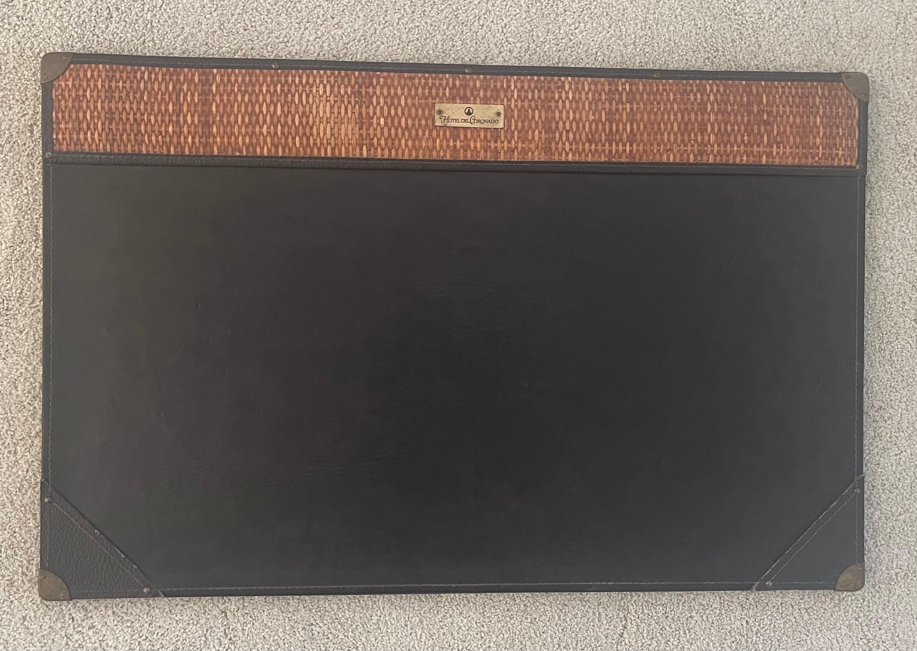 Vintage Hotel del Coronado (San Diego, CA Landmark Hotel) leather and cane desk blotter, circa 1970s. The piece is quite rare and unique and was used in the hotel in the 1970s and 1980s. The piece is in very good condition, measures 28