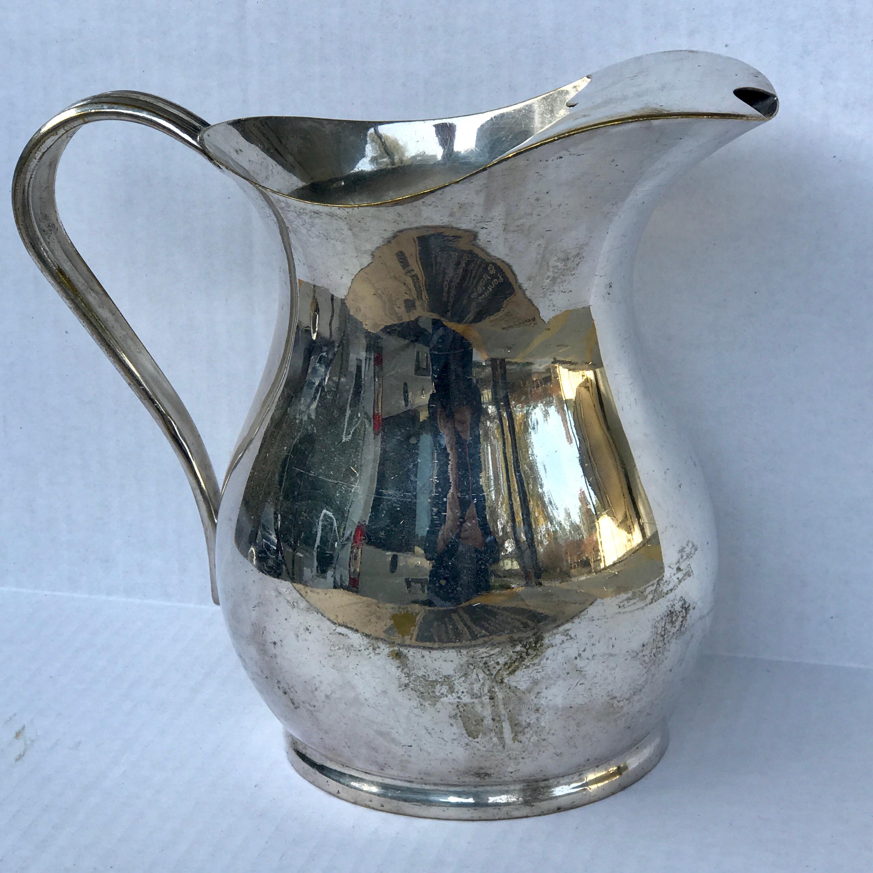 Vintage hotel silver plated water pitcher, with splash guard, stamped Silver Soldered, great distressed patina and wear, minor dents, no structural issues presents beautifully.
 