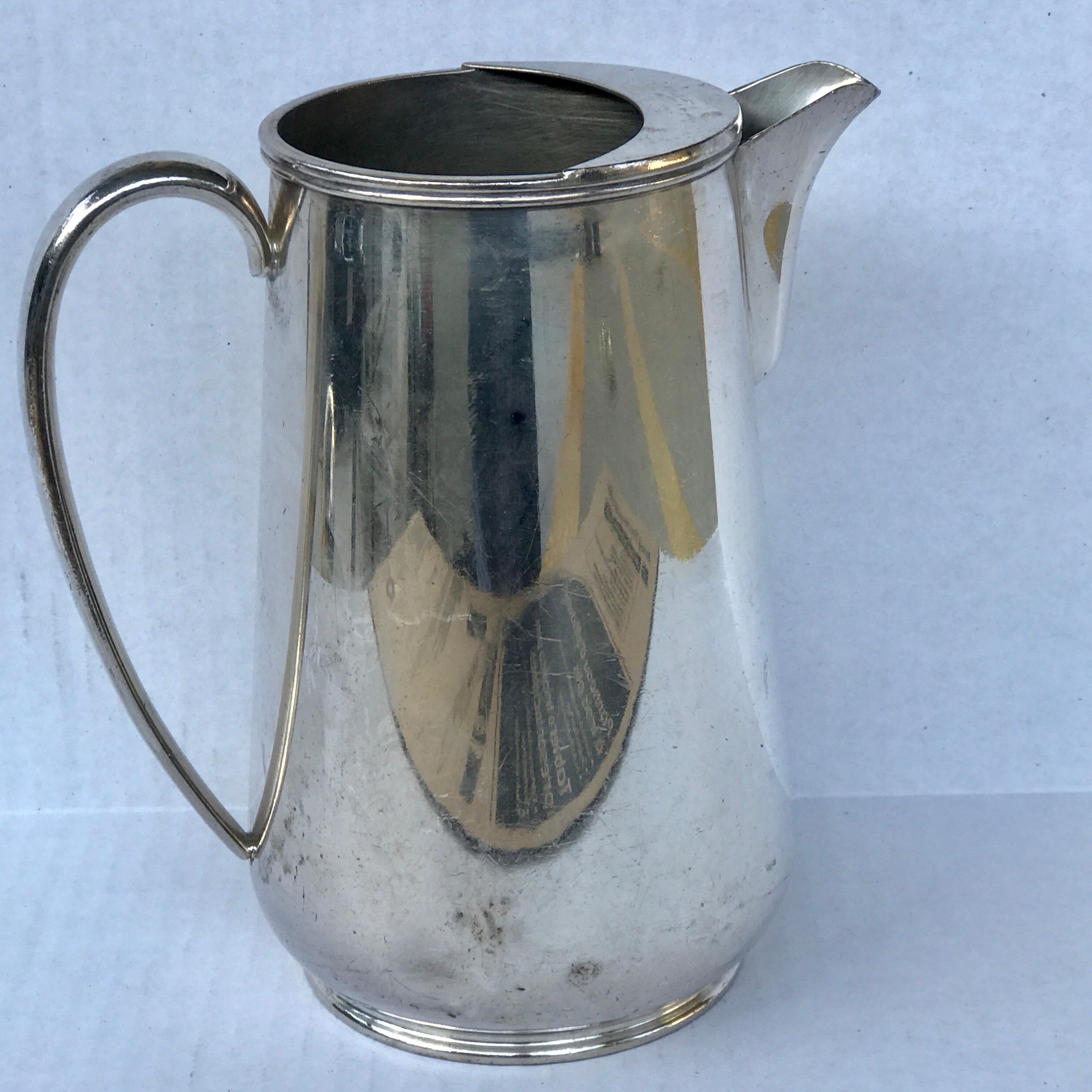 Vintage hotel silver plated water pitcher, with splash guard, stamped International E.P.N.S Japan , great distressed patina and wear, minor dents, no structural issues presents beautifully.

 