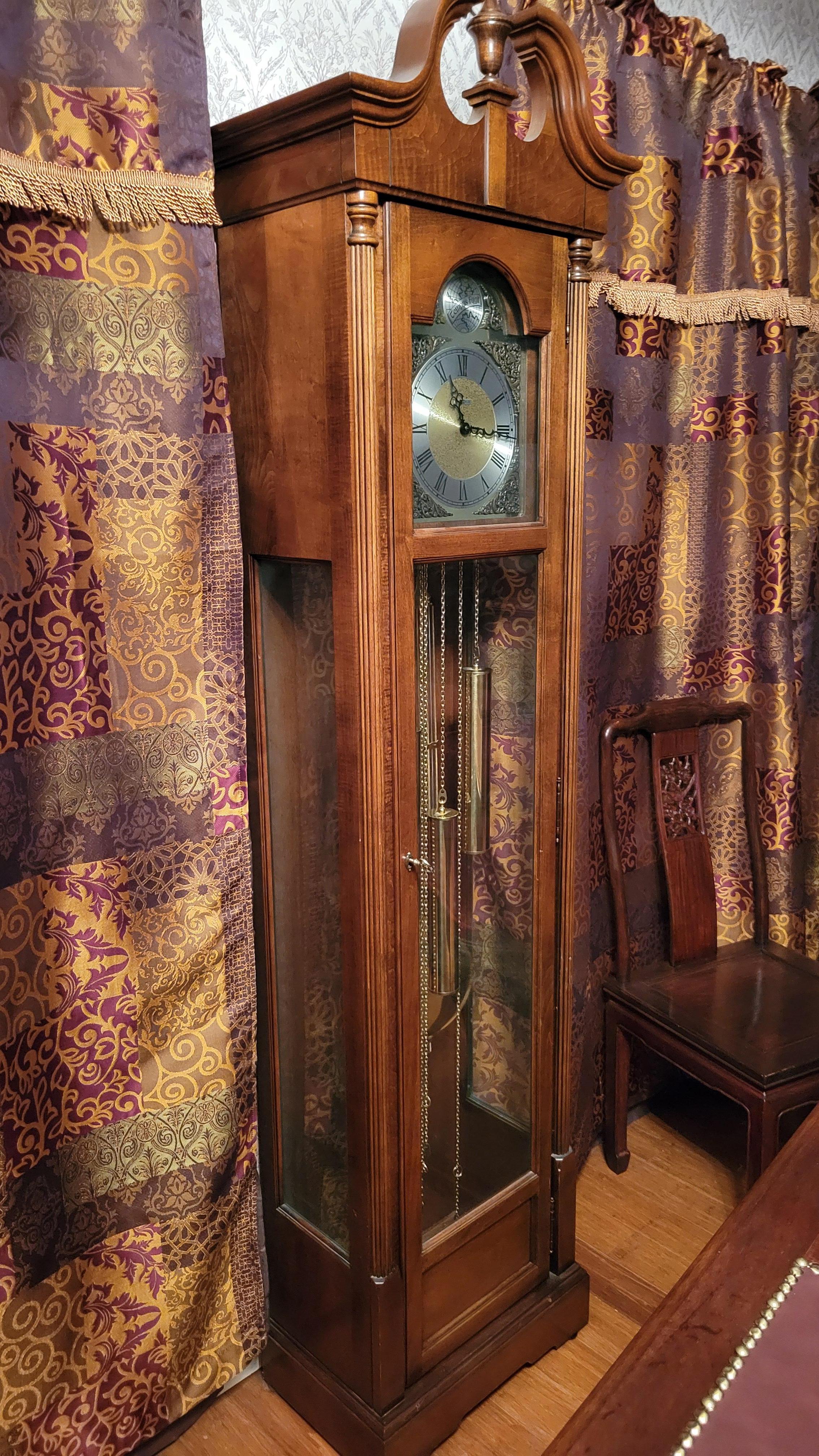 Howard Miller Cameron 610-185 Grandfather Clock
This floor clock features glass panels on three sides of the case, an urn finial,  and the polished brass pendulum. The case locks with a key.
The movement is 451-060H, chain-driven with Westminster