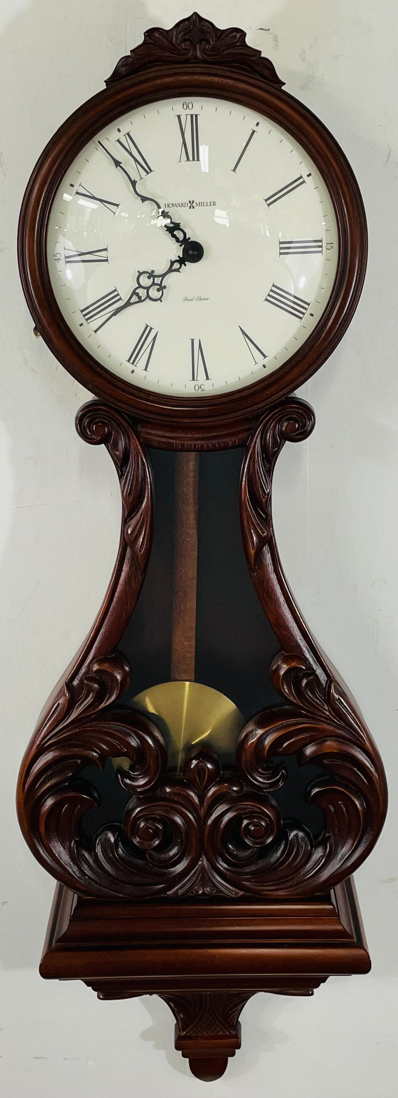 A Classic Howard Miller Valencia wall clock , model 620-236. The vintage clock features great Mahogany wood carving details . The clock is Quartz with Dual chime movement and has its original label with serial and model number. 

Dimensions: 35