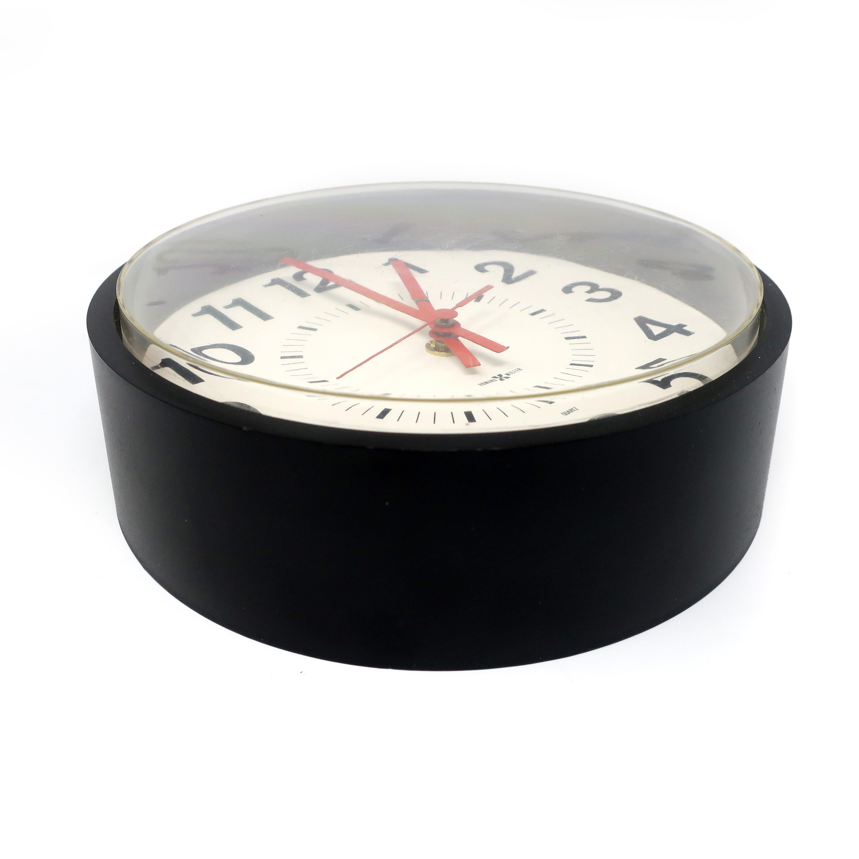 A vintage Howard Miller wall clock with a black plastic body, white face, and black hand and numbers. This clock has a clean mid-century modern look that looks perfect at home or at your office or business.

In very good vintage condition with