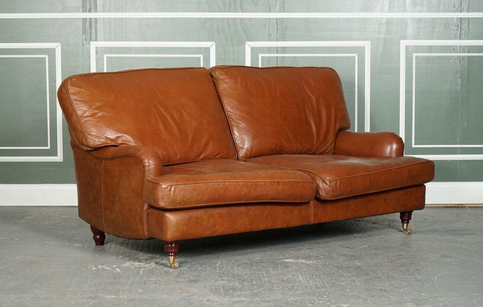 We are delighted to offer for sale this Vintage Brown Leather Howard Style 2 to 3 Seater Sofa.

For the price you'll get a a very stylish and well made sofa, and very similar to the popular Howard & Sons signature style.
The sofa is raised on two