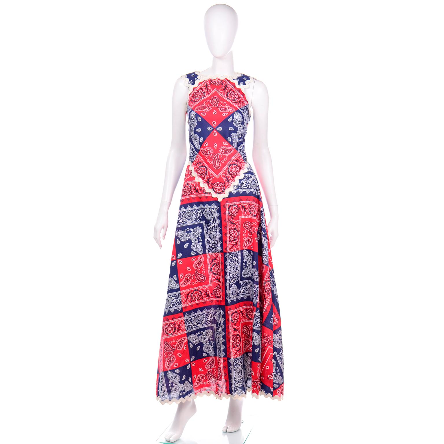 We adore this fabulous Howard Wolf deadstock early 1970's red and blue bandana patchwork print dress with ivory rick-rack trim. This dress has a high square neckline similar to an apron style dress. The straps are thick and have white rick-rack trim
