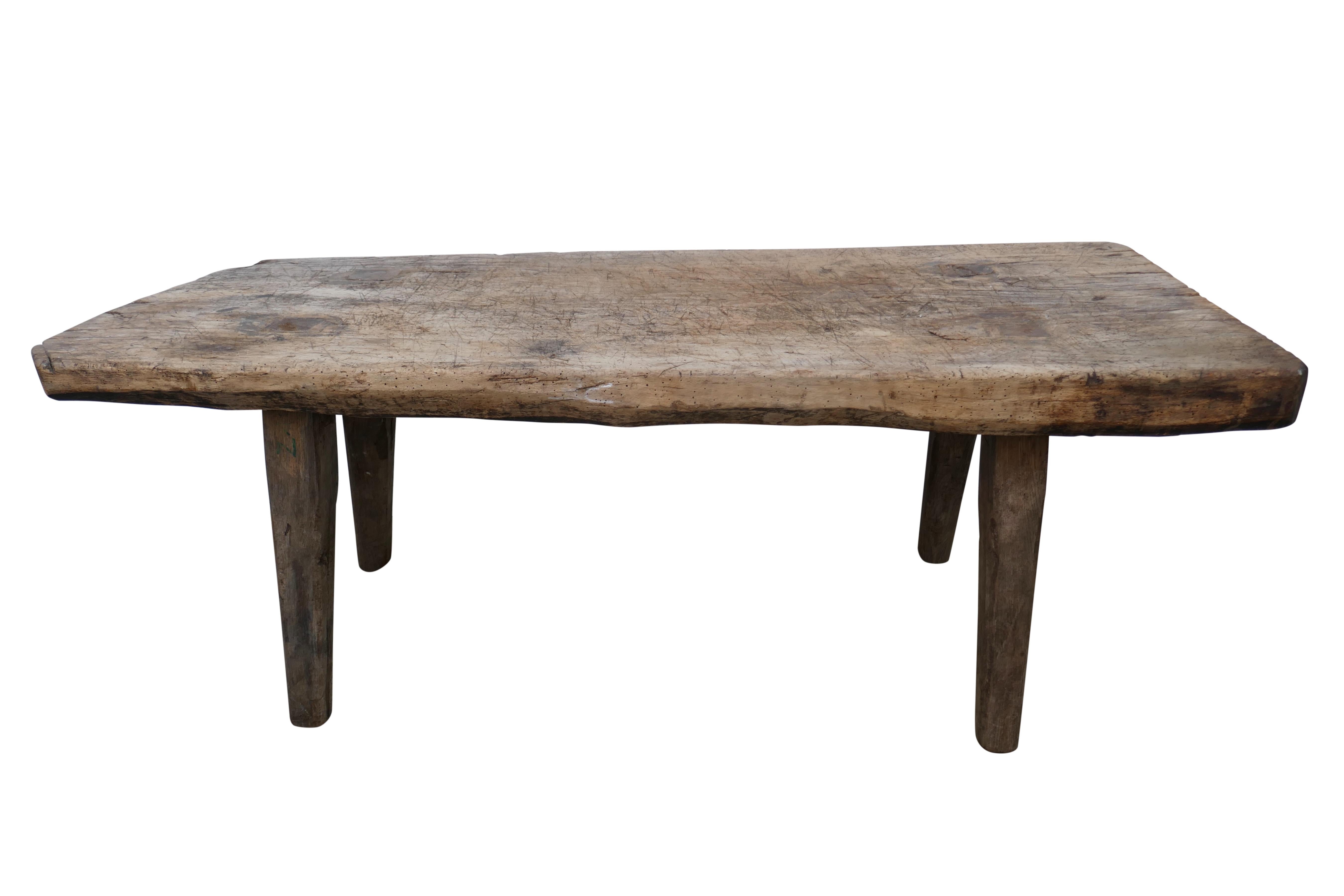 An outstanding example of a Hungarian vintage rustic table. Primitively hand-crafted and carved of solid heavy-weight oak featuring beautiful time created age character and patina throughout. This particular piece is extremely solid with chunky 3