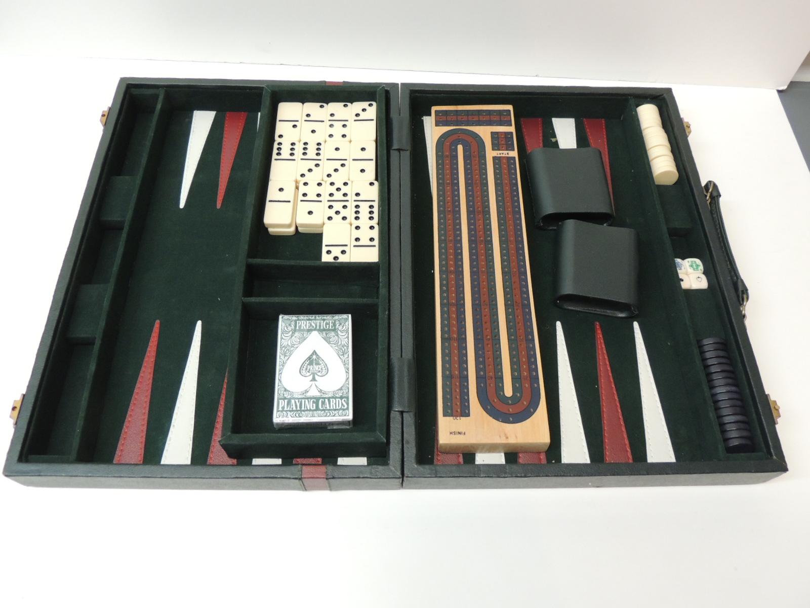 Mid size hunter green and red backgammon game set with dominoes, cards and cribbage included.
Red and white details inside with instruction on how to play all those games included in the set. Briefcase shape.
Size: 22.5 W x 16