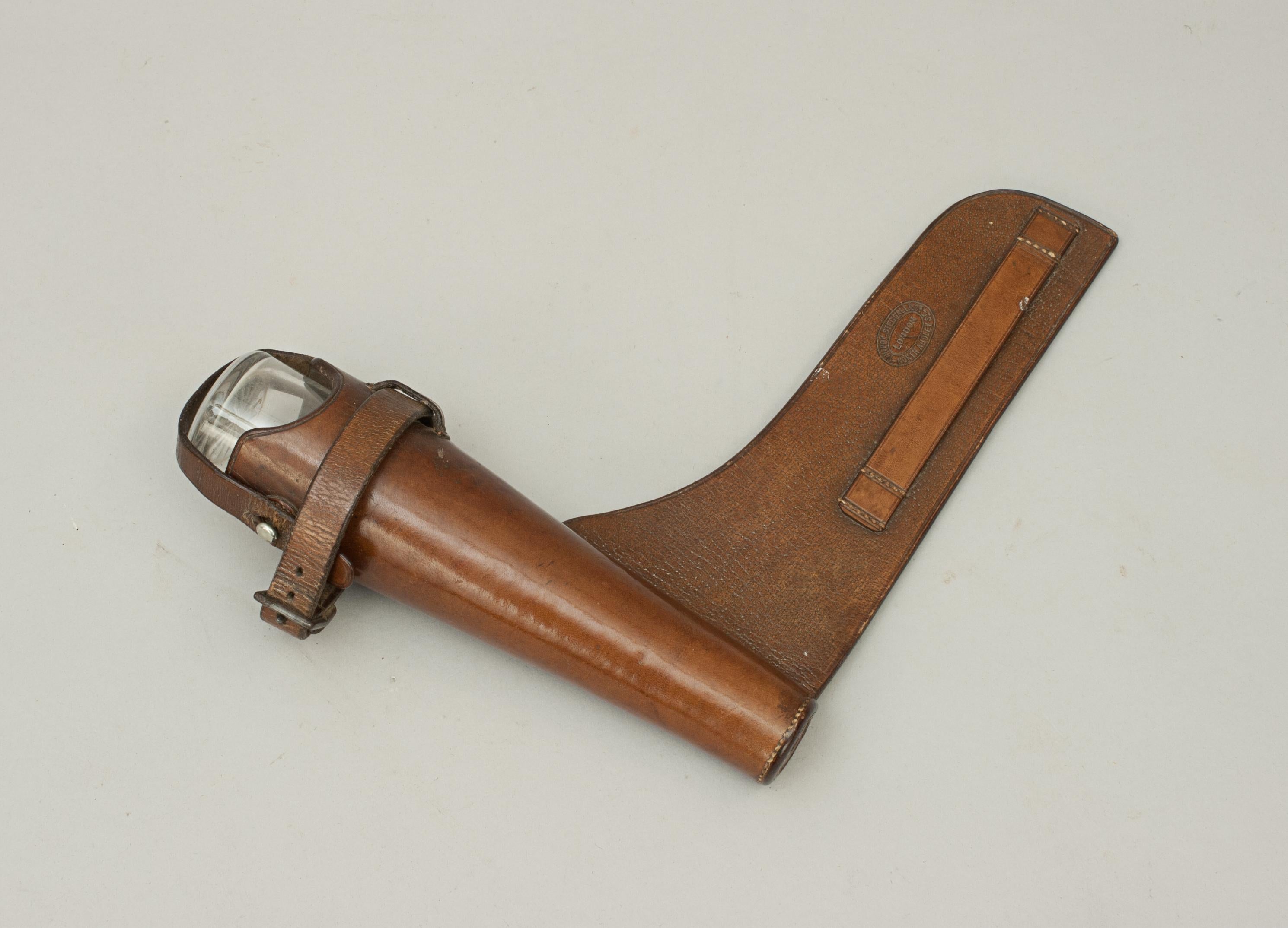 Vintage conical glass hunting saddle flask.
A beautiful small and unusual ladies hunting flask, conical shape with plated top and bayonet fitting, contained in original leather saddle case made by Whippy Steggall & Co, North Audley Street, London.