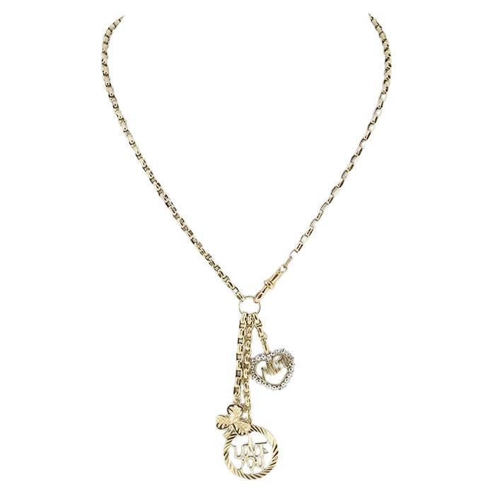 This is a vintage 9ct yellow gold belcher chain link necklace. The necklace showcases a trio of matching charms including an open 'Mum' love heart, a three leafed clover and open round charm crafted to read the words 'I Love You'. This necklace is