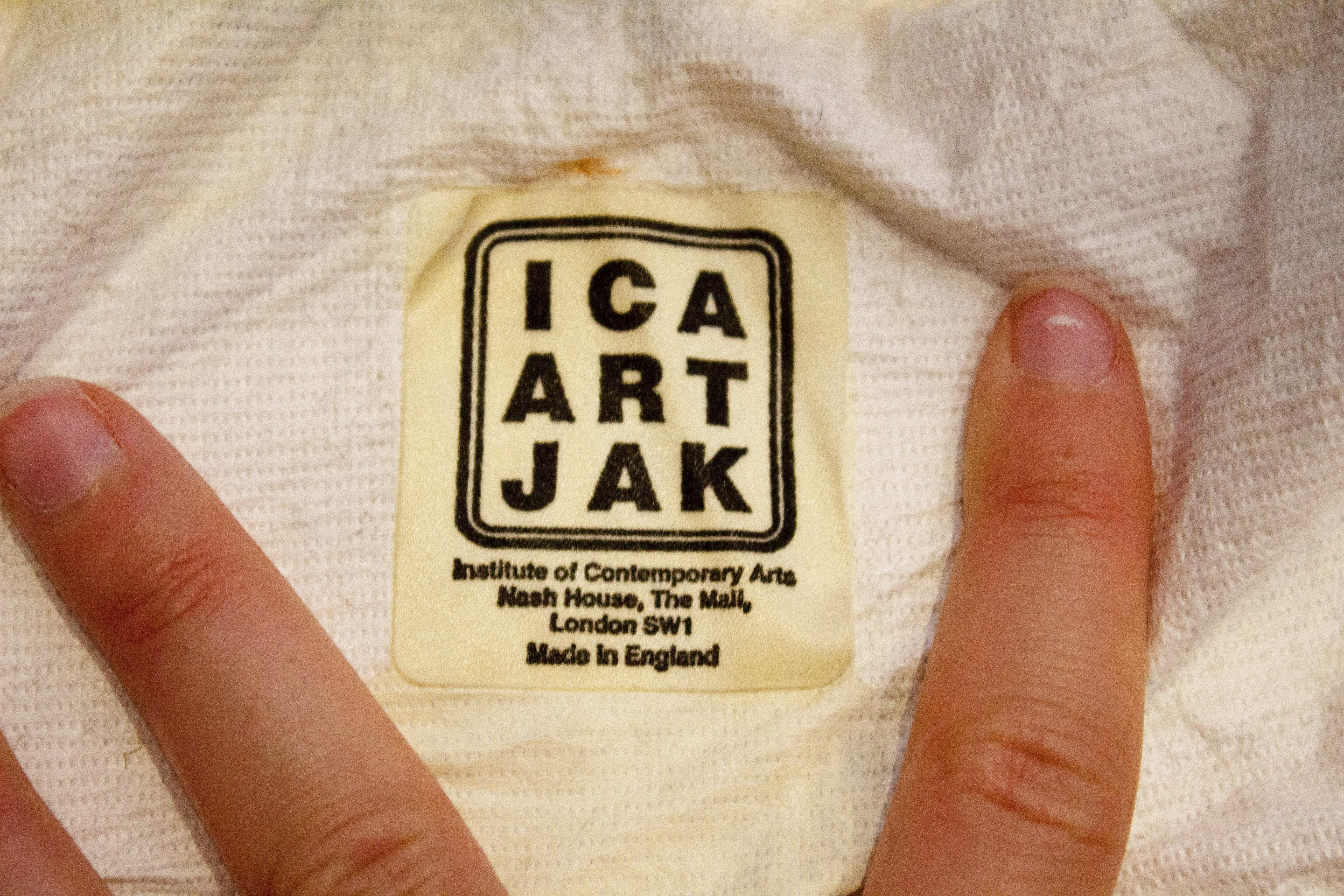 A great vintage jacket from the Institute of Contemporary Arts ( ICA) in London. The jacket has a zip front opening with ribbing on the collar , cuffs and hem. It  has a sliver background with a black print and red rose on the top left hand side.