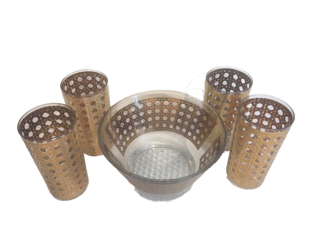 Mid century ice bowl and eight highball glasses in the Canella pattern by Culver. Canella is one of the most sought after Culver patterns, decorated in 22 karat gold with a raised textured surface, it is designed to imitate woven cane. The ice bowl