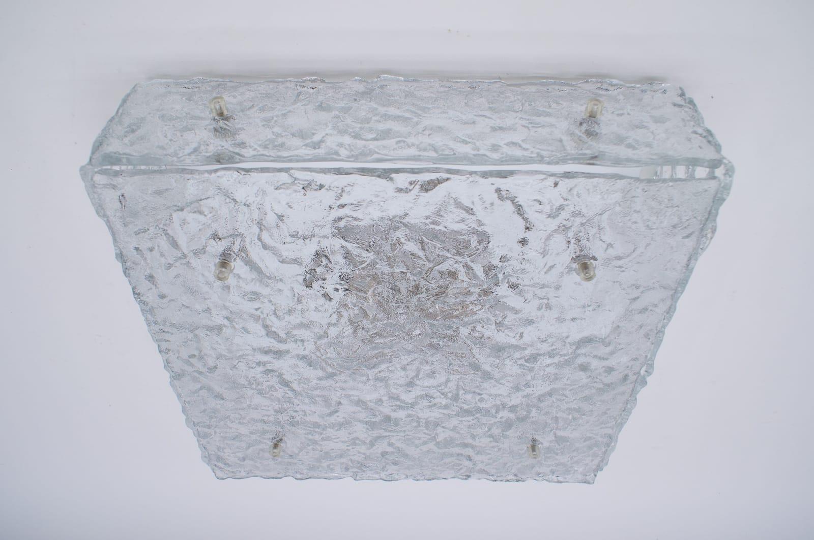 This large flushmount was produced in Austria by Kalmar in the 1960s. It is composed of 12 thick textured ice glass elements attached to a white frame and uses four E27 bulbs.