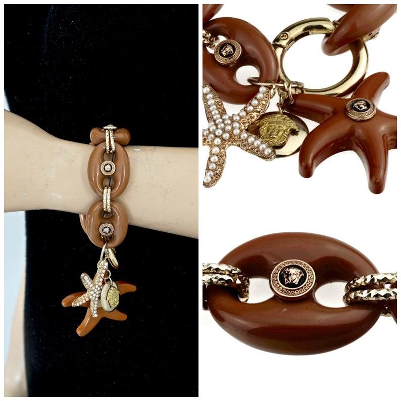 Vintage Iconic 1992 GIANNI VERSACE Medusa Starfish Bracelet

Measurements:
Height: 2.36 inches (6 cm)
Chain: 1.10 inches (2.8 cm)
Length: 8.46 inches (21.5 cm)

Features:
- 100% Authentic GIANNI VERSACE.
- Iconic medusa medallion accents.
- Starfish