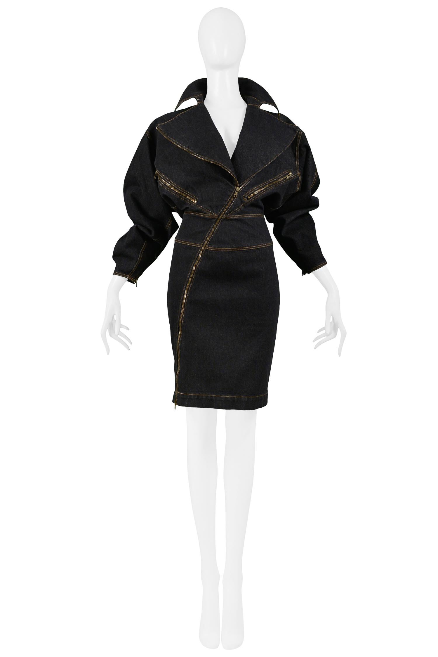 Vintage Azzedine Alaia black denim dress with an oversized collar, contrasting yellow topstitching, an asymmetrical bronze zipper, front and back zipper pockets, fitted skirt, and knee-length. The bodice has a relaxed, comfortable fit, and the skirt